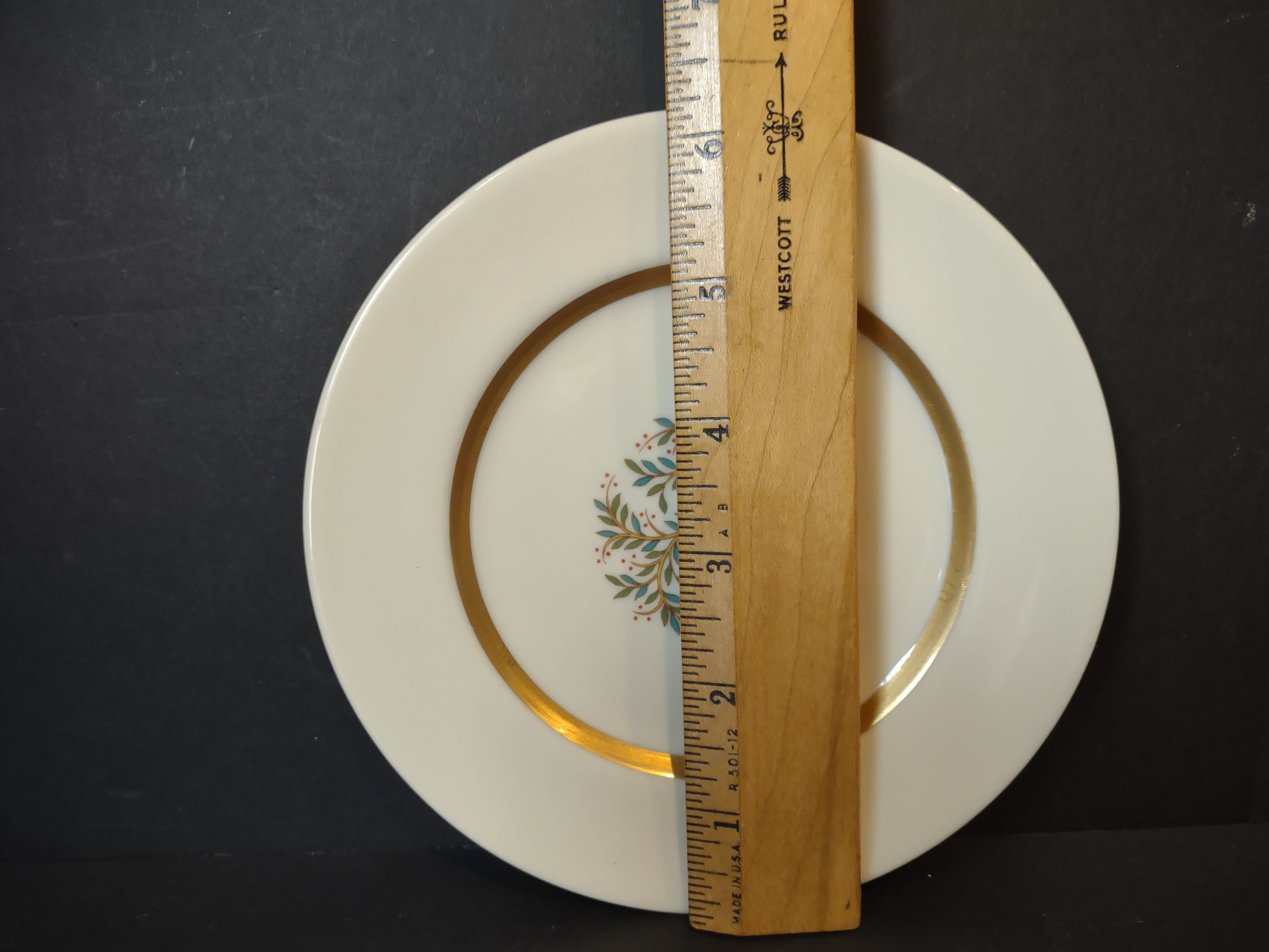 Vintage Franciscan China Fremont plate front view showing teal floral sprig center and wide gold band border, approx 7.5 inches