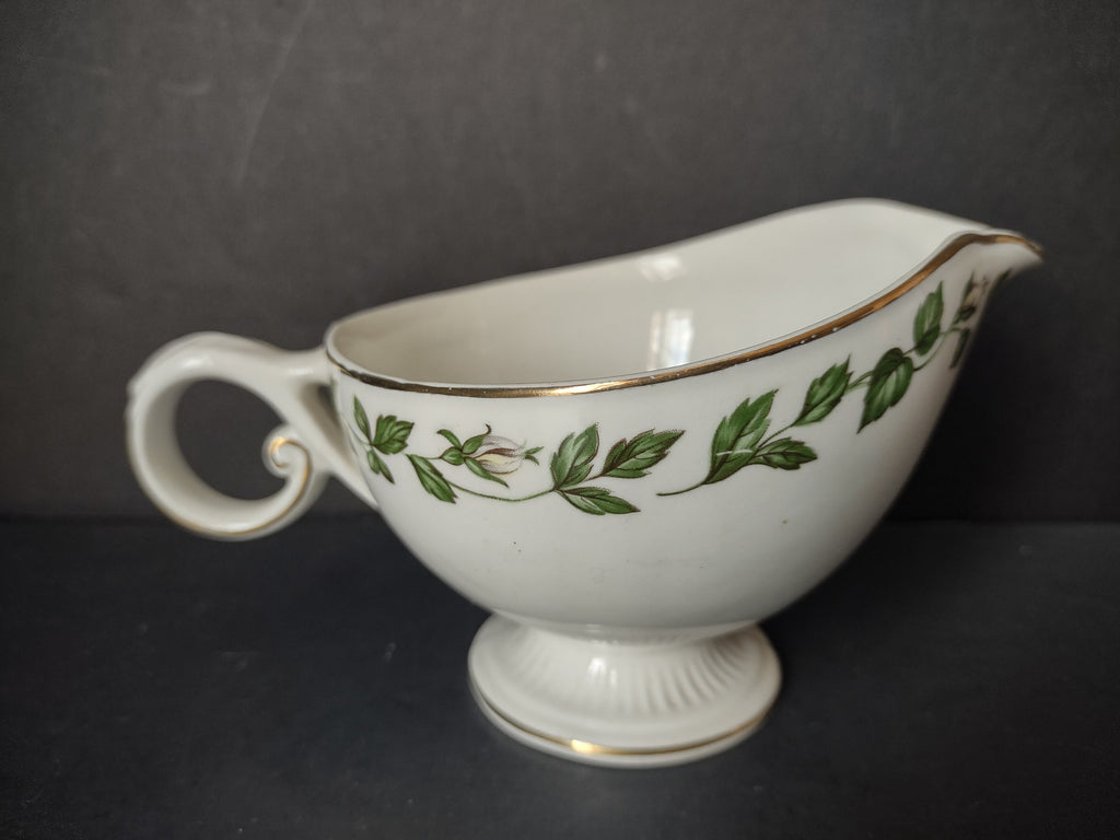 Vintage green ivy garland gold trim porcelain gravy boat - front left view showing full pattern