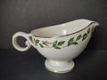 Vintage green ivy garland gold trim porcelain gravy boat - front left view showing full pattern