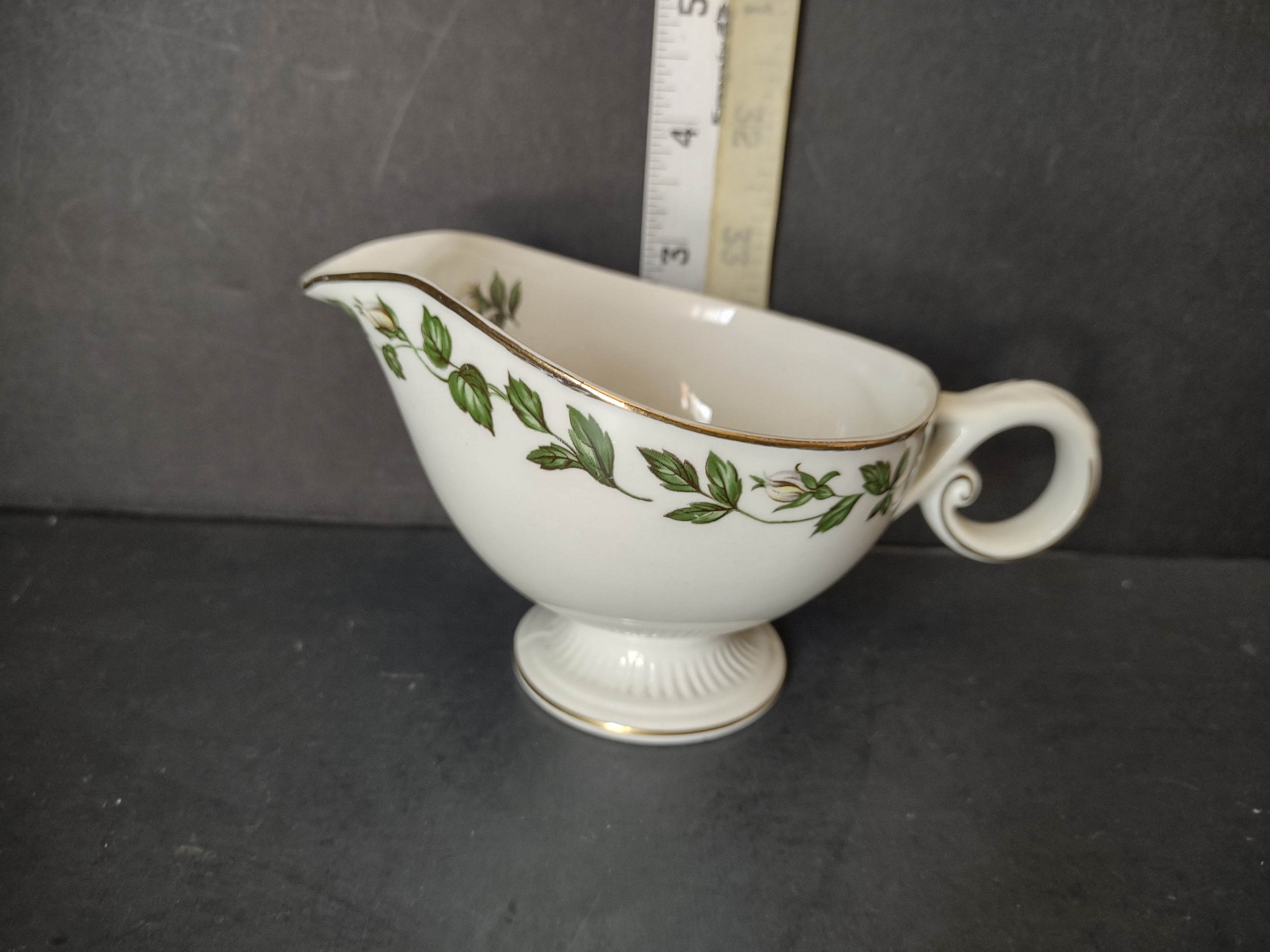 Vintage green ivy garland gold trim porcelain gravy boat - base view showing unmarked bottom and footed pedestal