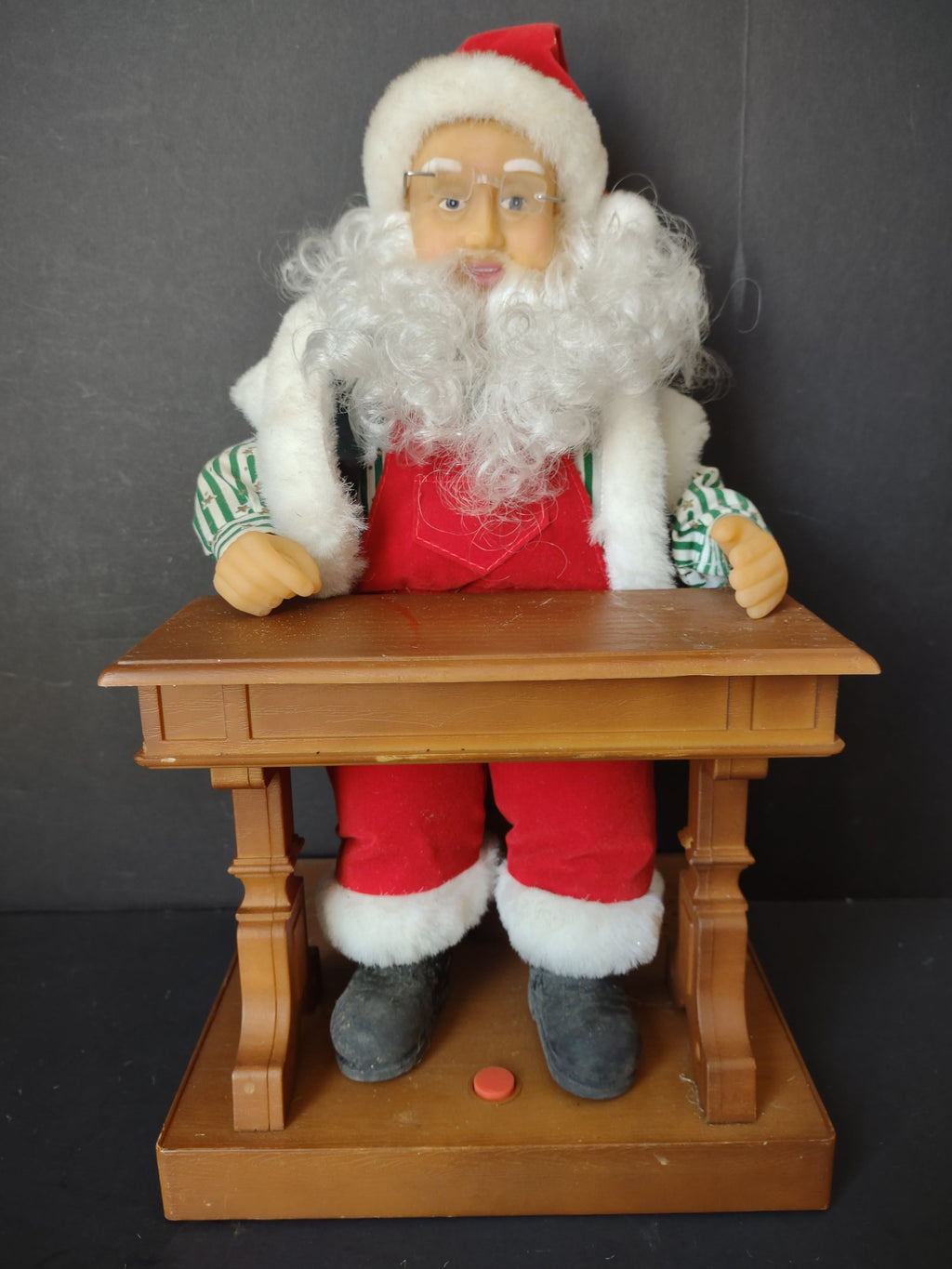 Vintage animated Santa Claus at school desk - right side view showing striped shirt sleeves and desk detail