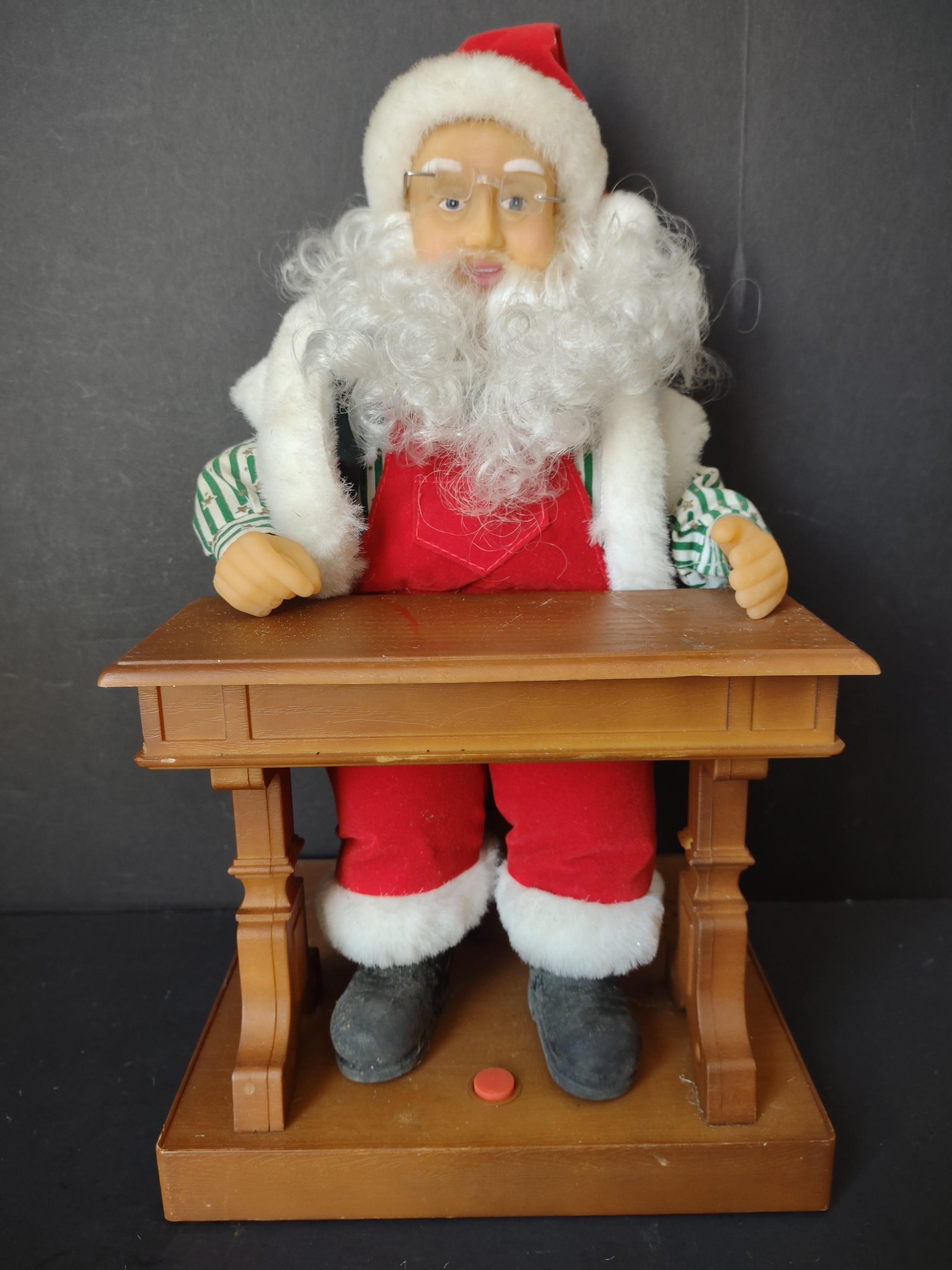 Vintage animated Santa Claus at school desk - right side view showing striped shirt sleeves and desk detail