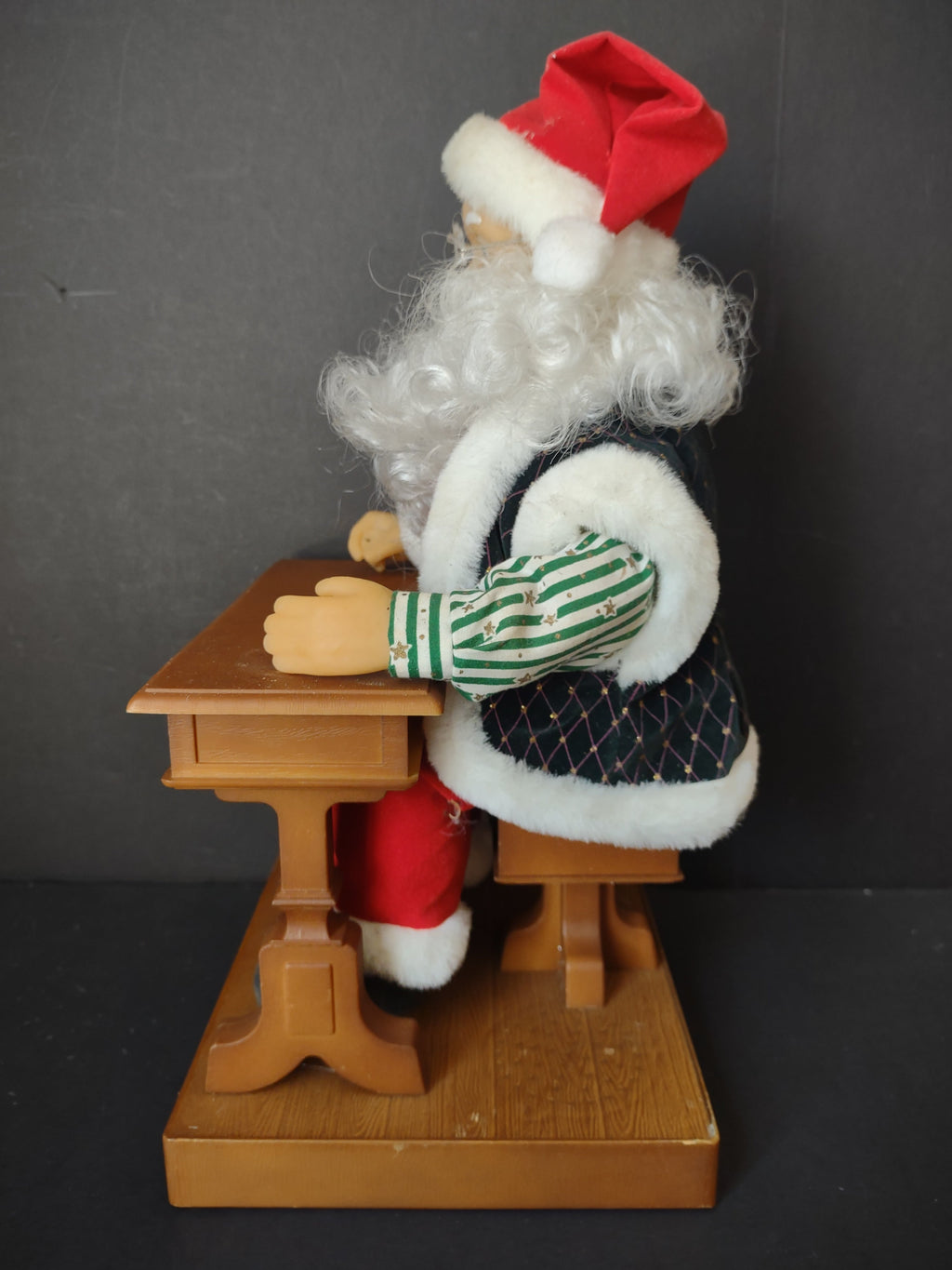 Vintage animated Santa Claus at school desk - back view showing green diamond-quilted velvet coat
