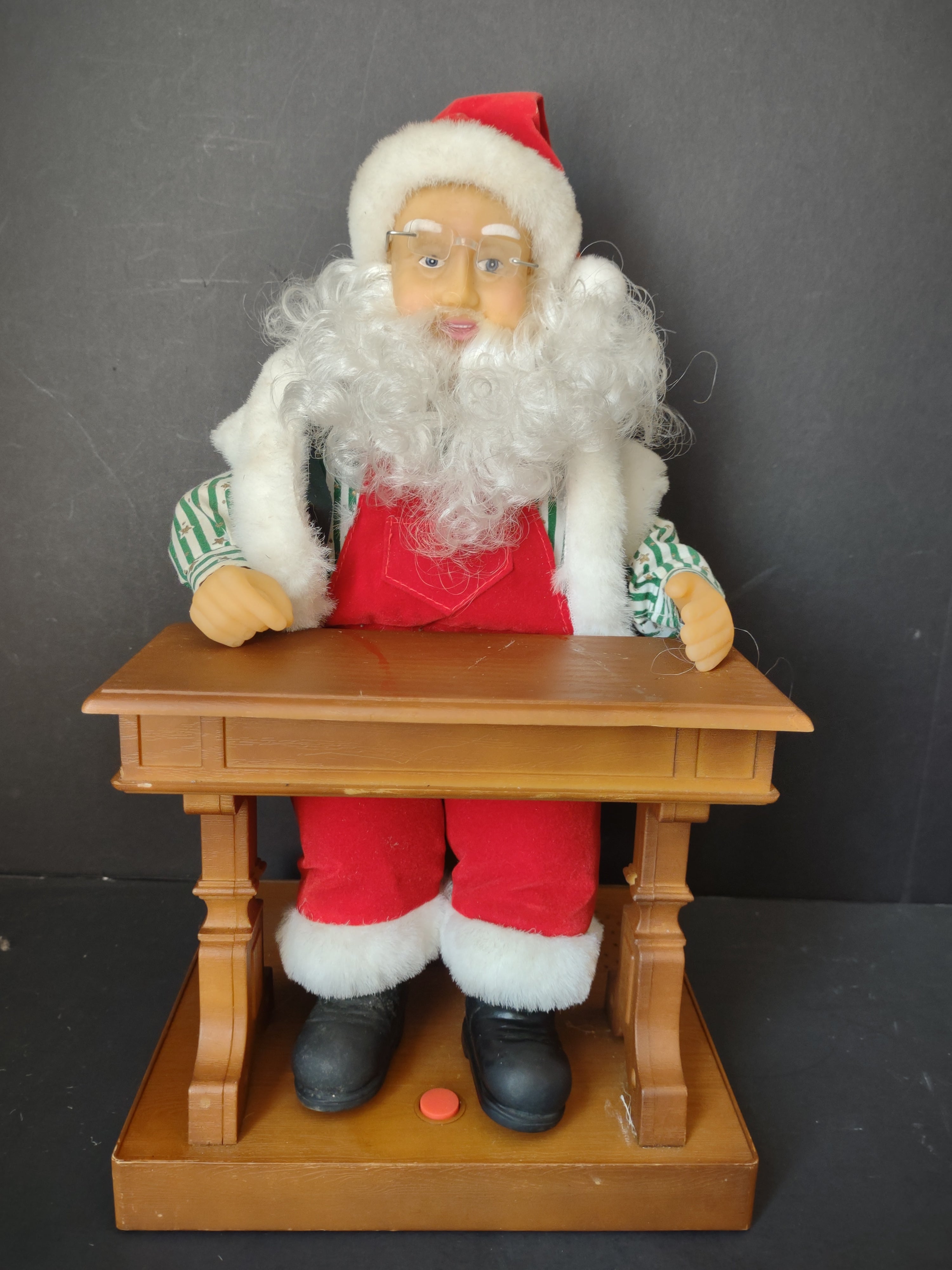 Vintage animated Santa Claus at school desk - left side view showing full figure with red pants and black boots