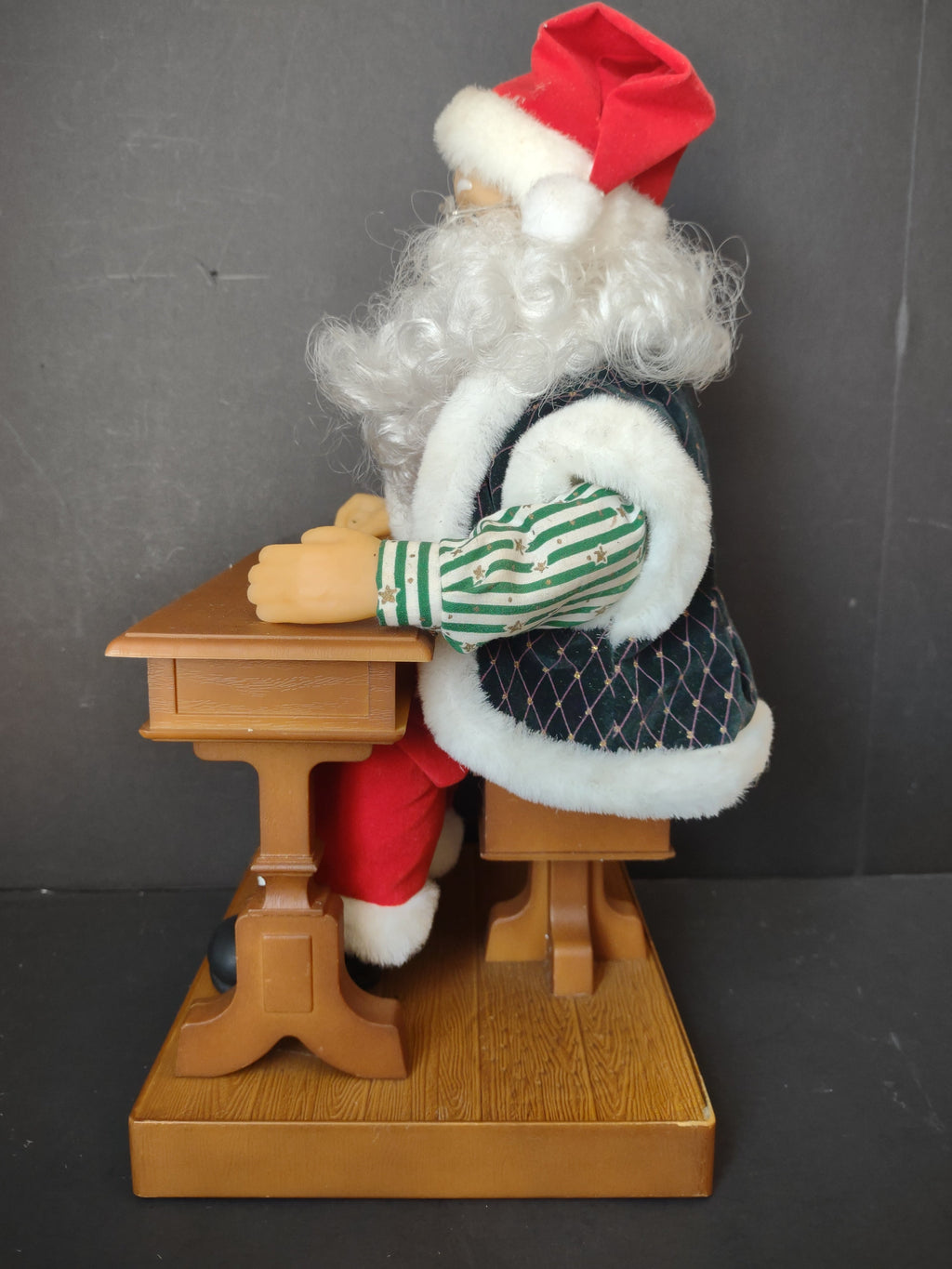 Vintage animated Santa Claus at school desk - close-up of desk and wooden base with red dot battery indicator