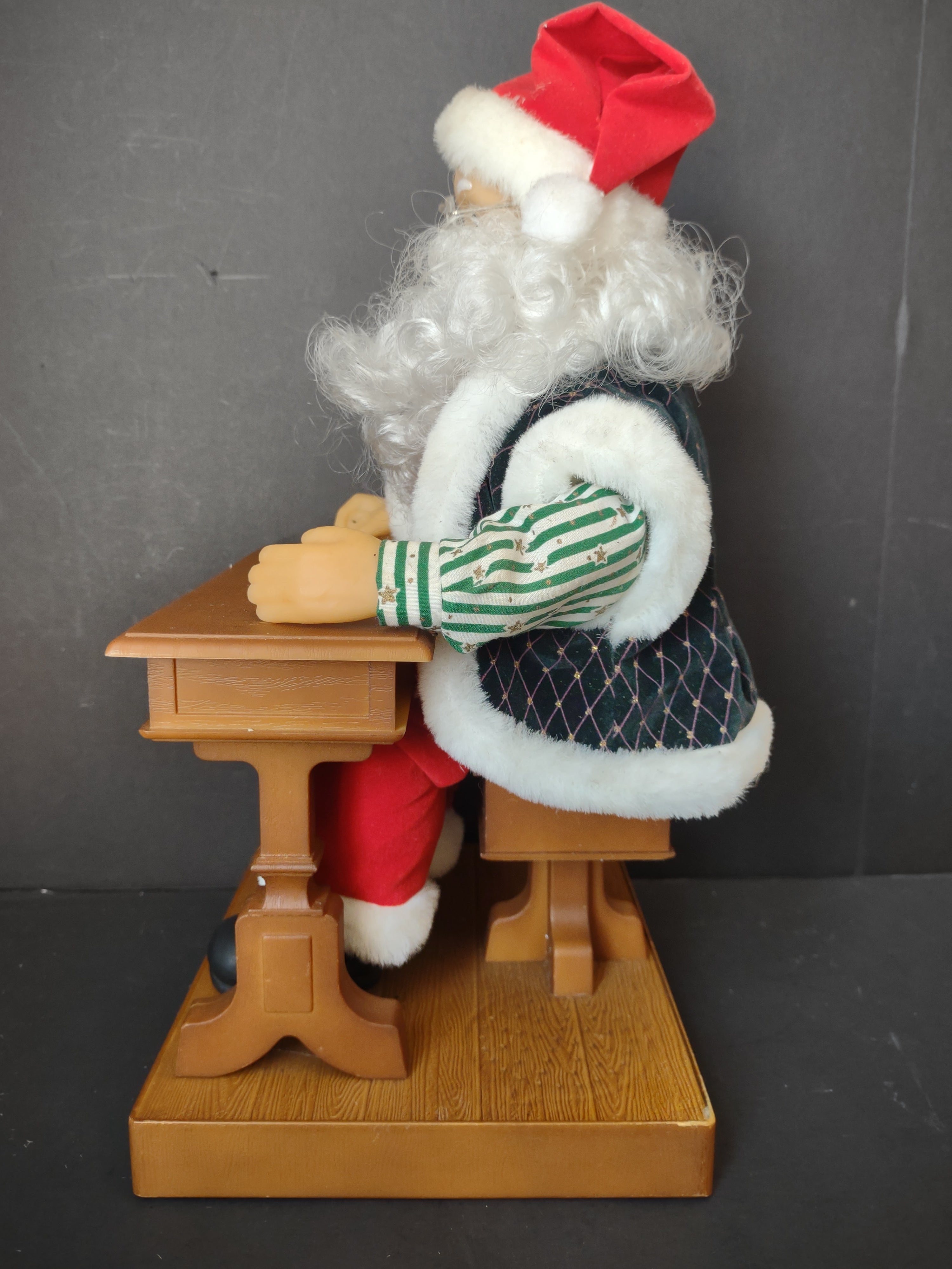 Vintage animated Santa Claus at school desk - close-up of desk and wooden base with red dot battery indicator