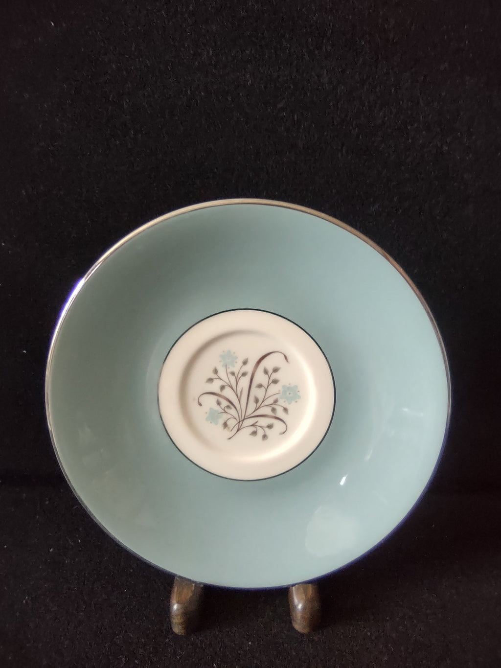 Syracuse China Meadow Breeze saucer close-up of center medallion with brown botanical branches and blue flowers