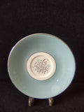 Syracuse China Meadow Breeze saucer close-up of center medallion with brown botanical branches and blue flowers