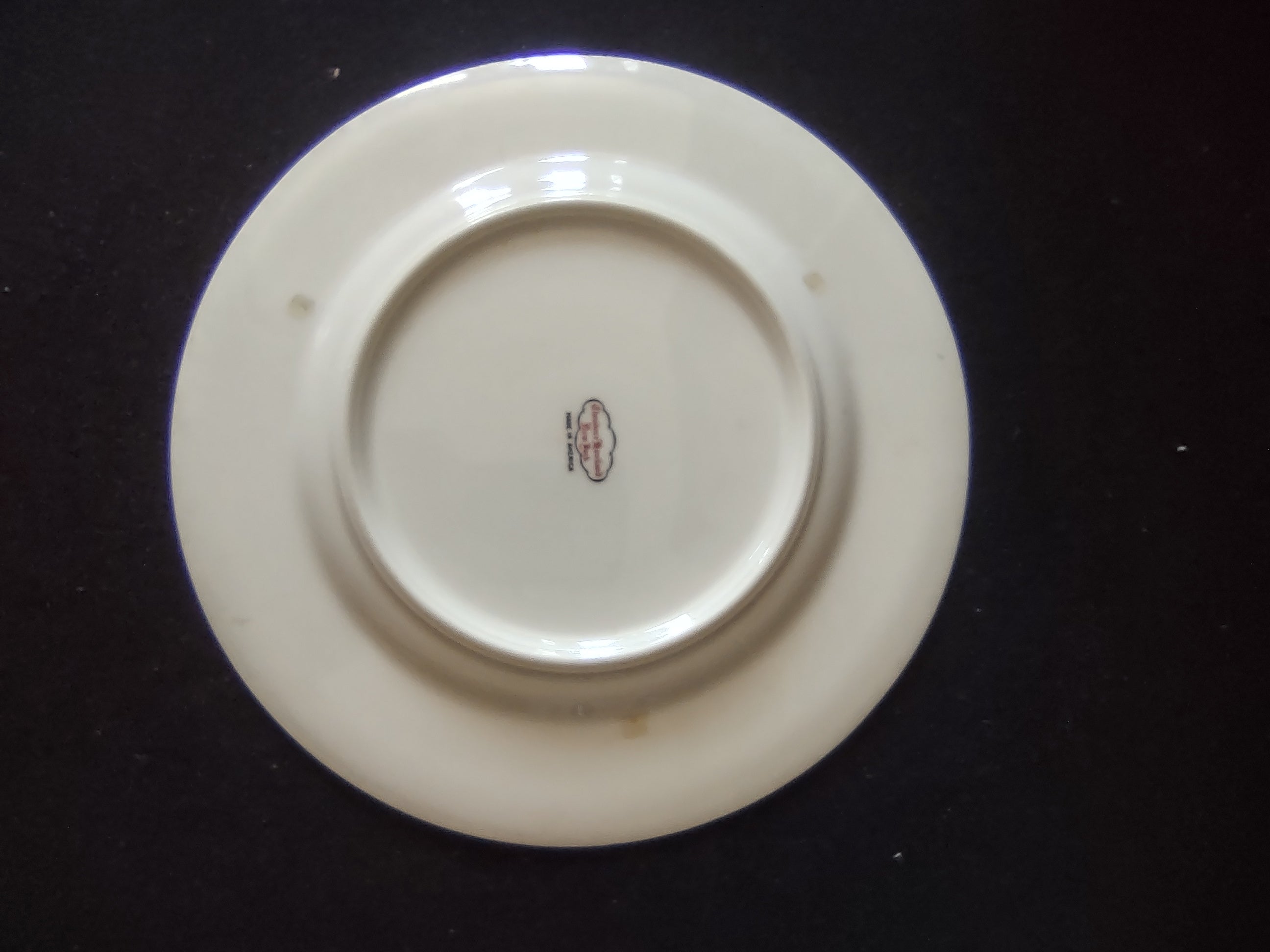 Set of 2 Theodore Haviland New York Art Deco red band plates on display stands showing front