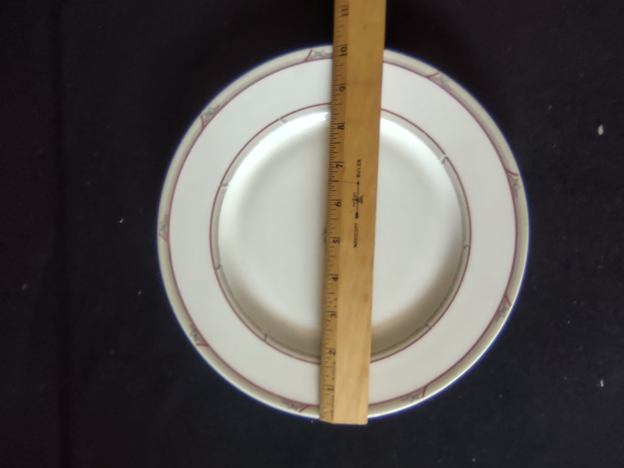 Close-up of red double bands with platinum accent line and crazing in glaze, pattern number 96300 visible