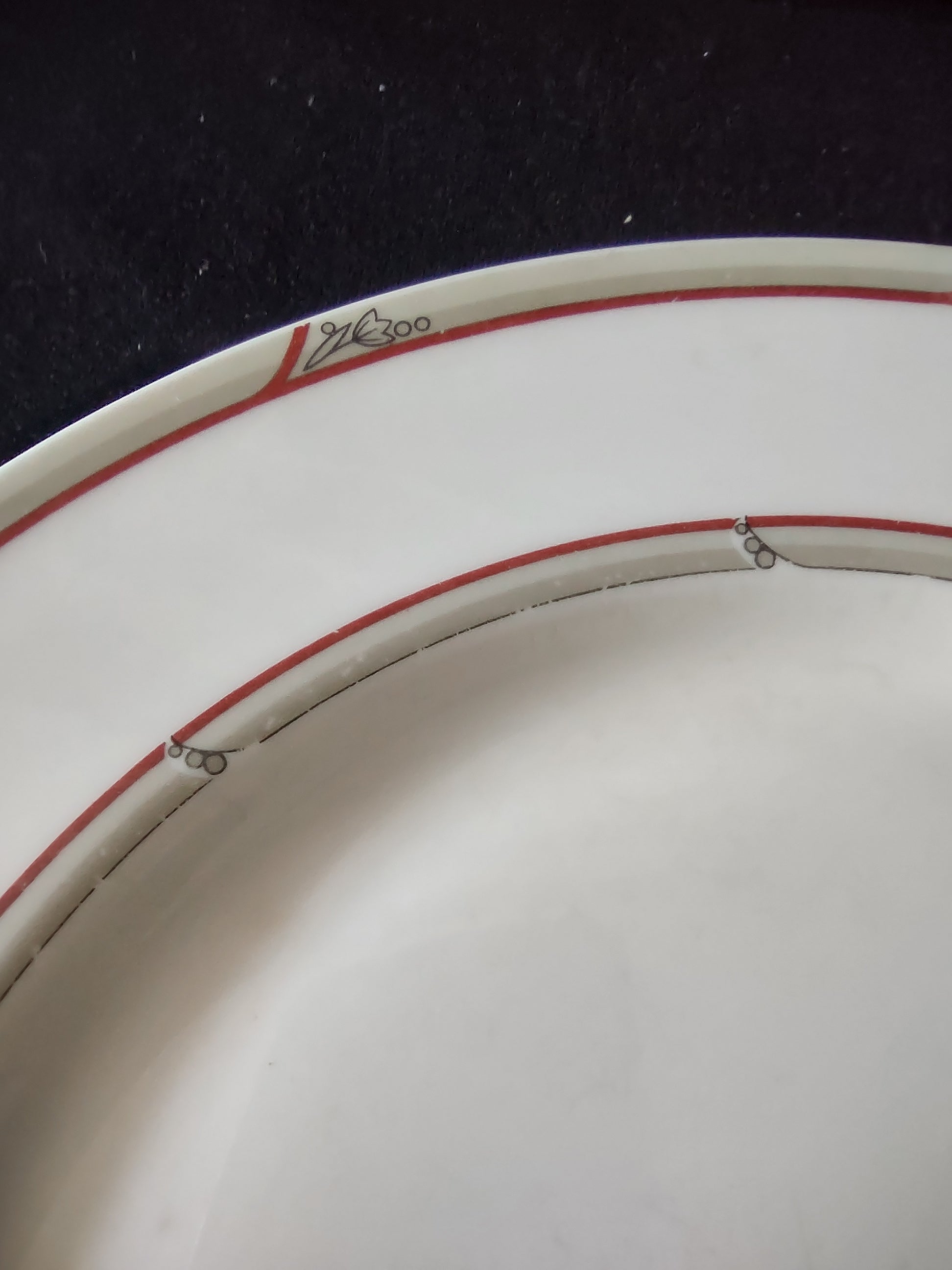 Close-up of red double bands showing age-appropriate crazing and stylized leaf motif detail