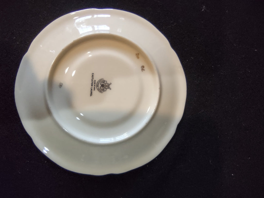 Close-up of Castleton Laurel gold laurel and floral garland pattern on saucer