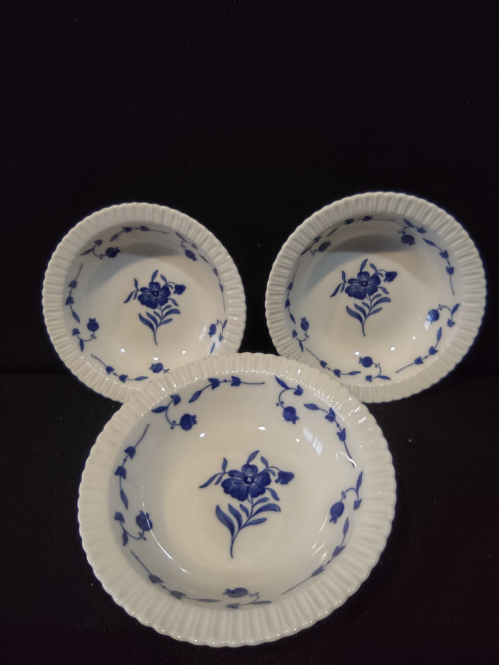 Set of 3 vintage Syracuse China Nantucket pattern bowls with cobalt blue floral center motif and trailing vine border on white porcelain with ribbed gadroon rim
