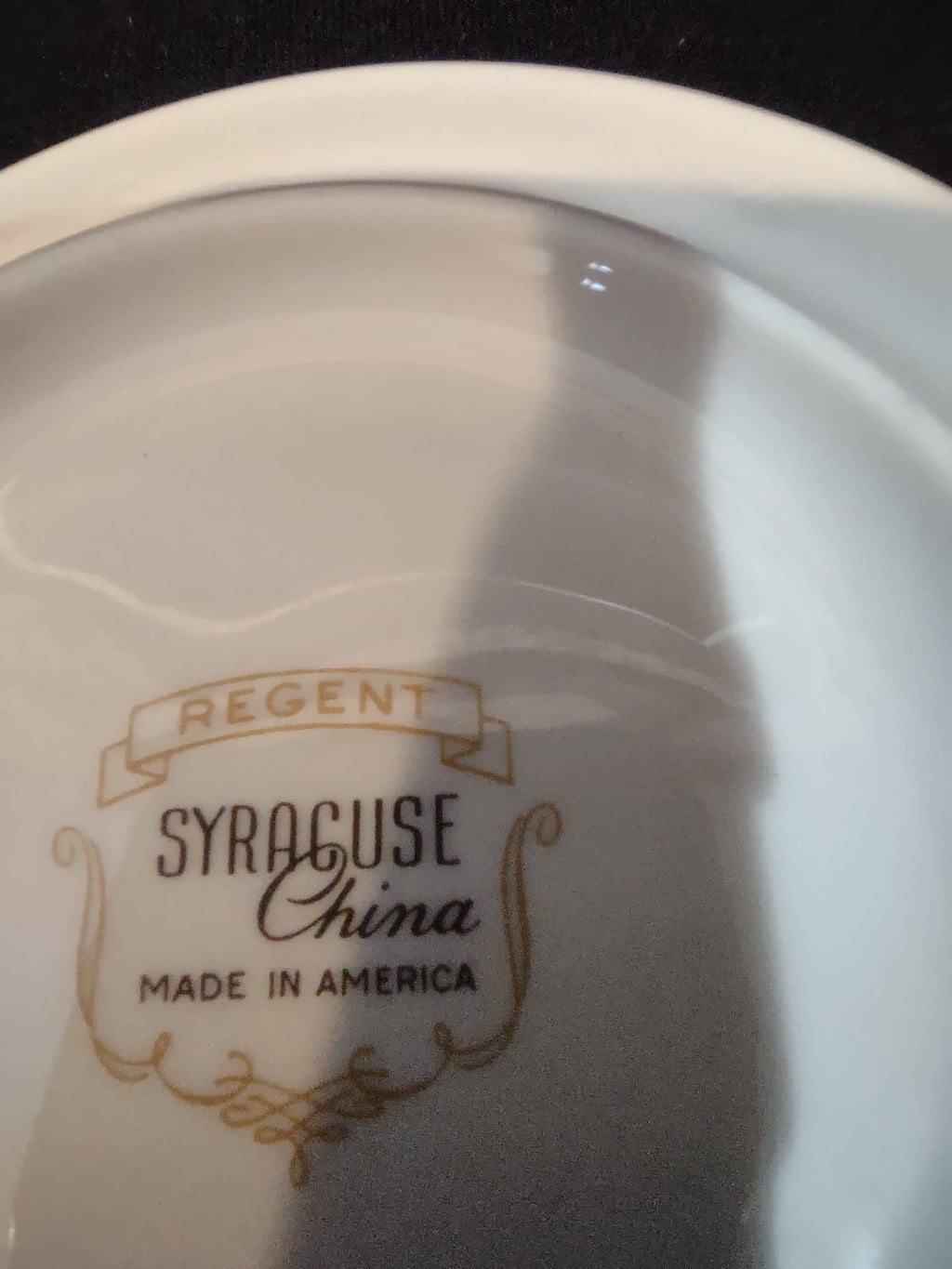 Backstamp reading Regent Syracuse China Made in America in gold on white porcelain base