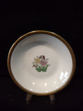 Vintage Theodore Haviland New York saucer with multicolor floral bouquet center motif — yellow, pink, and burgundy flowers with green leaves — and wide gold band rim on white porcelain