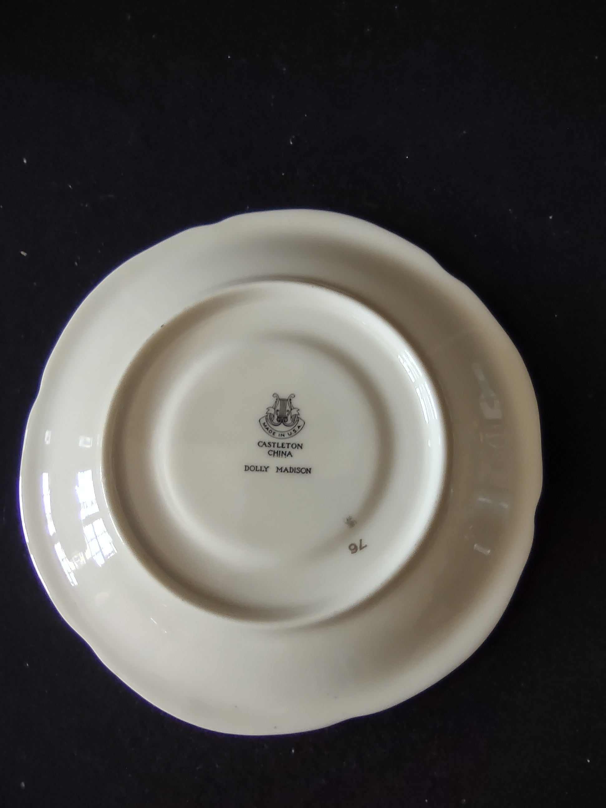 Side angle view of Castleton Dolly Madison saucer showing depth and beaded rim