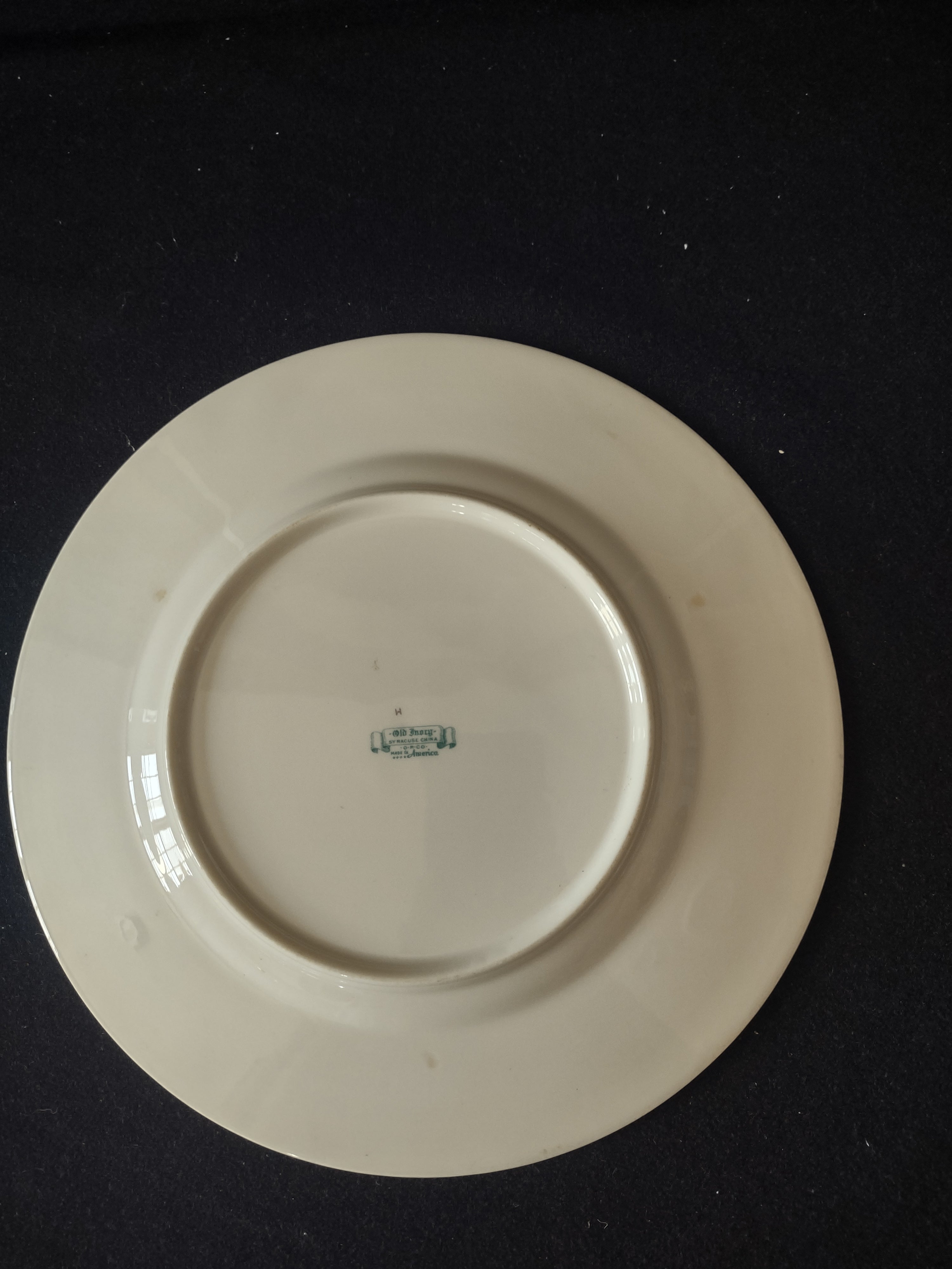 Syracuse China Old Ivory plate with ruler showing approximately 9.5 inch diameter