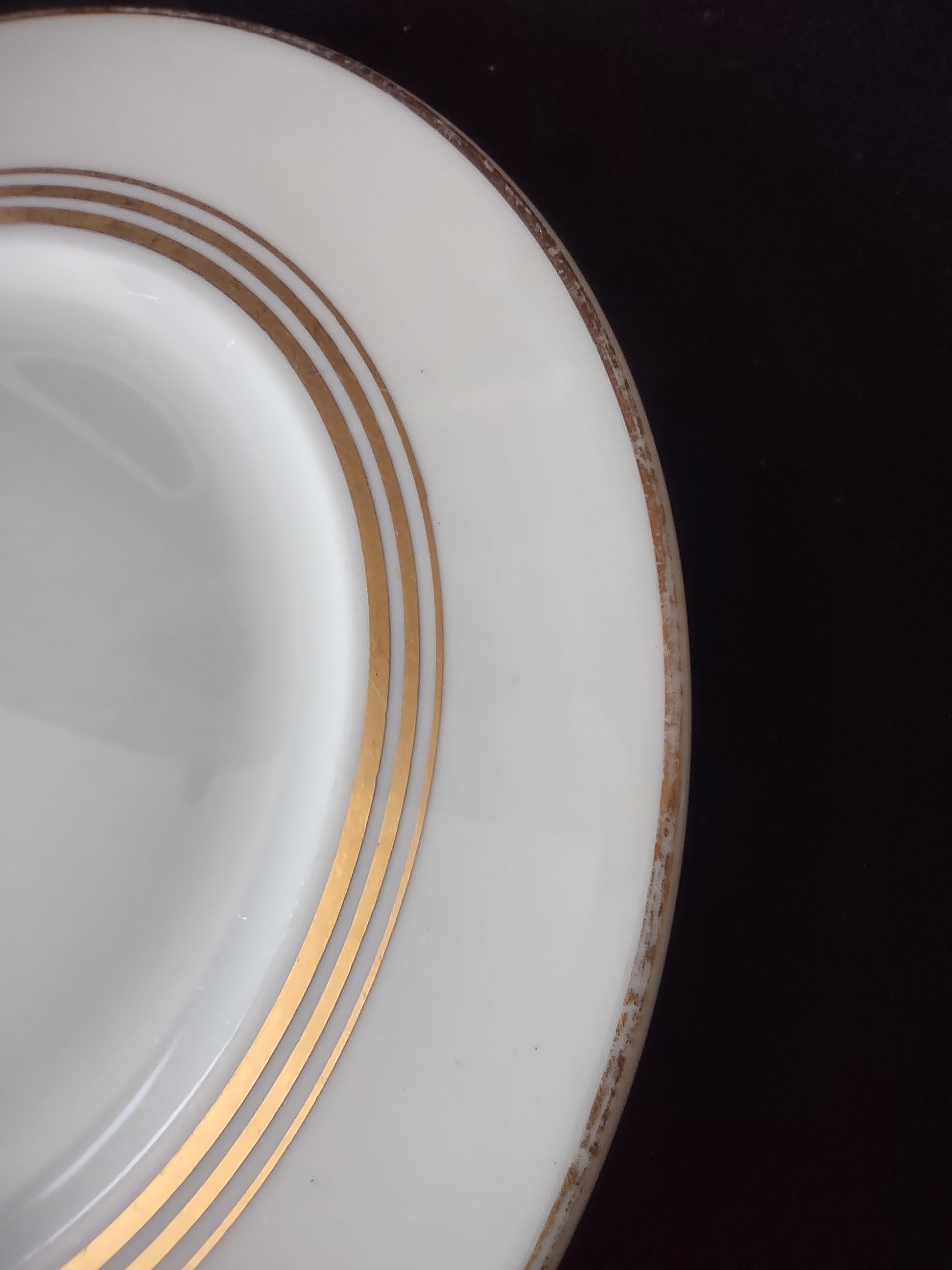 Set of 3 Syracuse China Old Ivory triple gold band plates displayed on stands