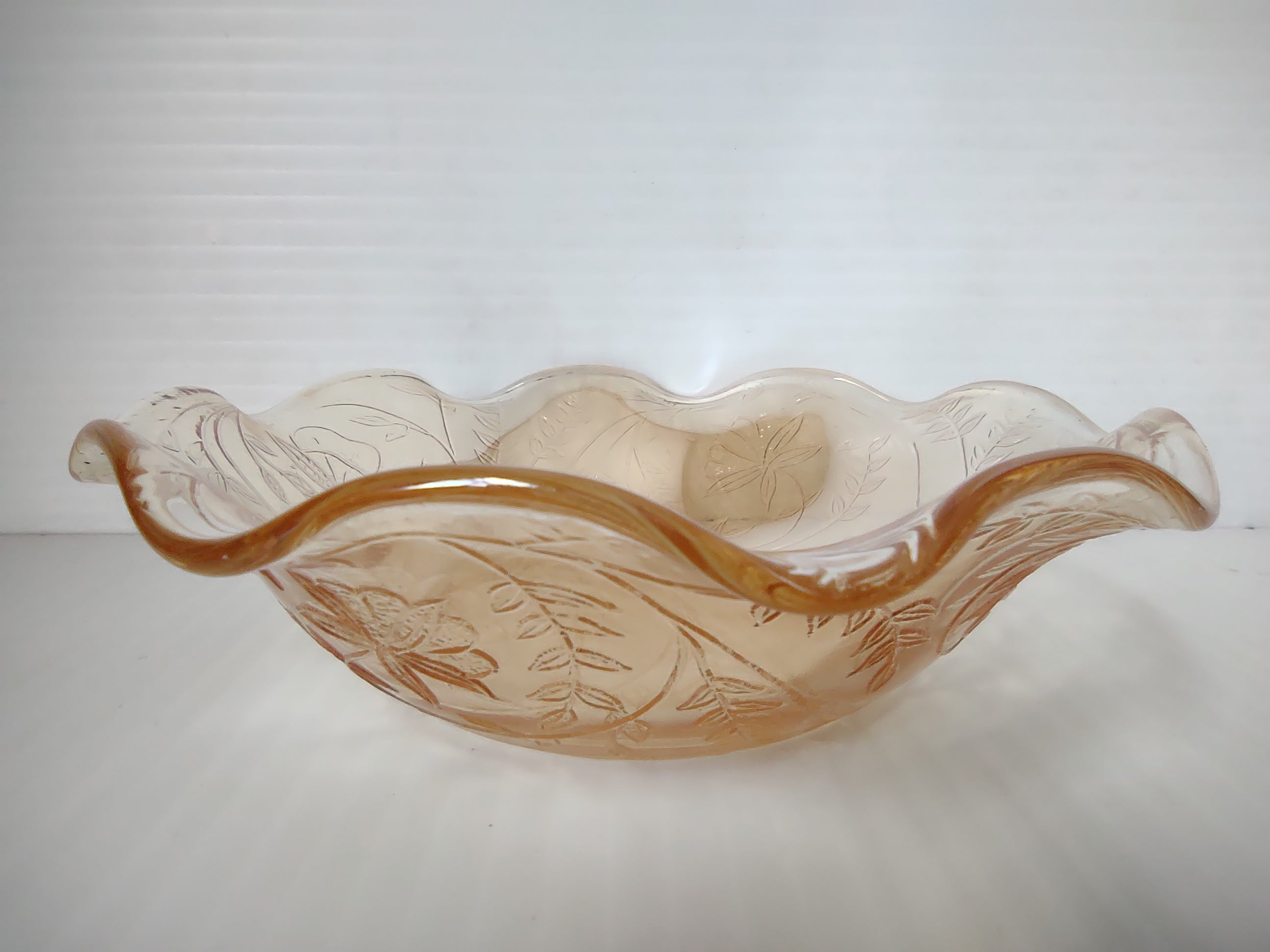 Vintage marigold carnival glass ruffled wave bowl rim close-up