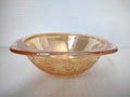 Side view of vintage marigold carnival glass square bowl with embossed grape leaf and berry pattern