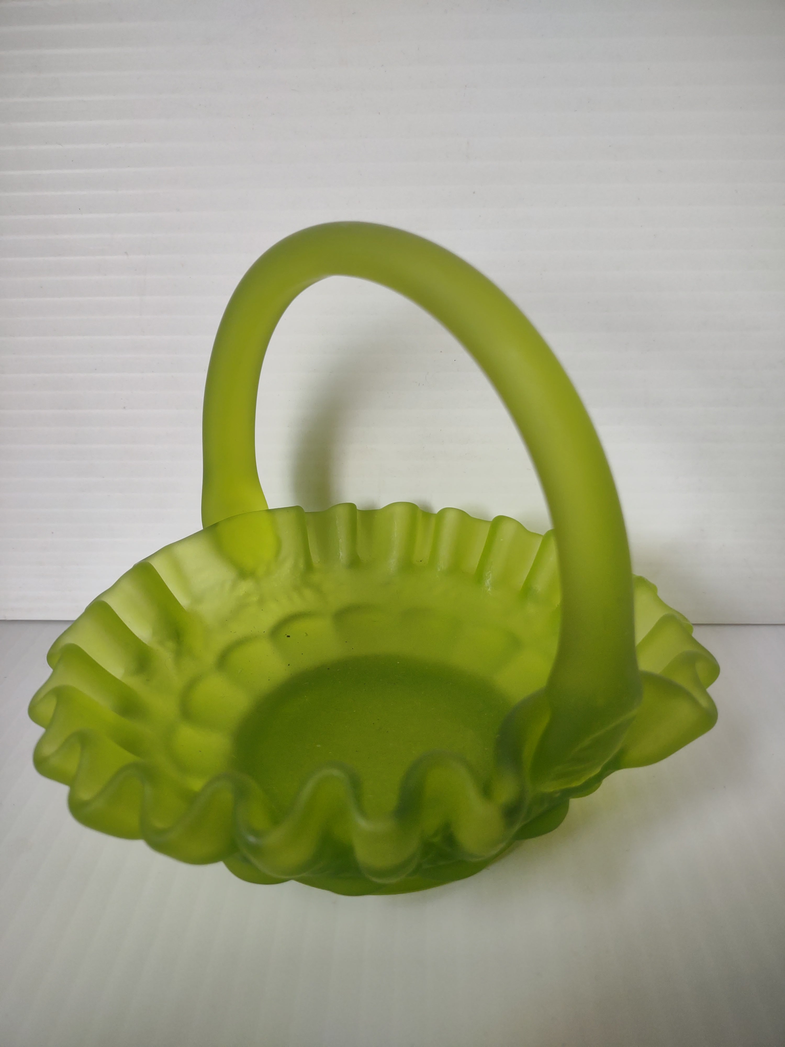 Front view of lime green satin glass hobnail ruffled basket with applied loop handle