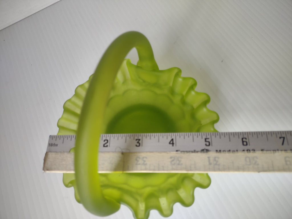 Ruler measurement showing lime green satin glass basket is approximately 5 inches wide