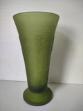 Close-up of embossed grape and vine pattern on olive green satin glass trumpet vase