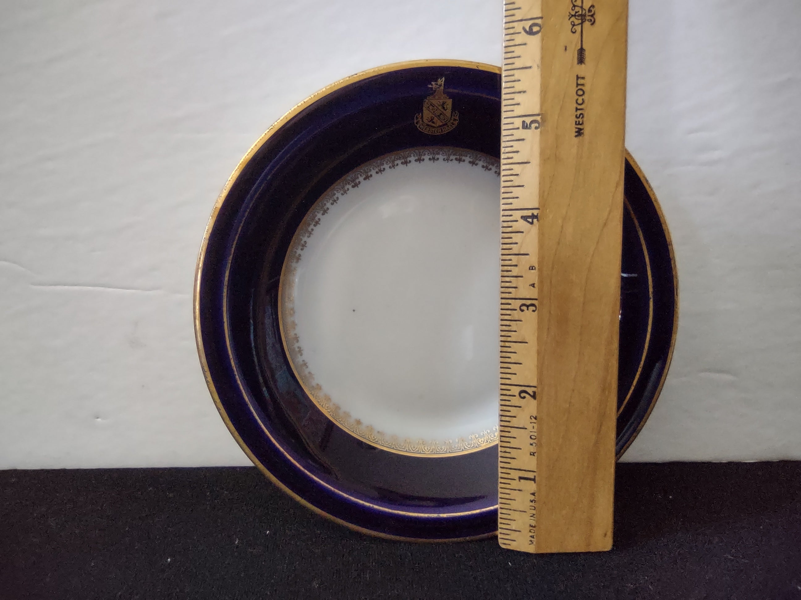 Vintage Black Knight Bavarian porcelain saucer with deep cobalt blue band, gold filigree inner border and gold heraldic crest, gold rim, approximately 6 inches diameter