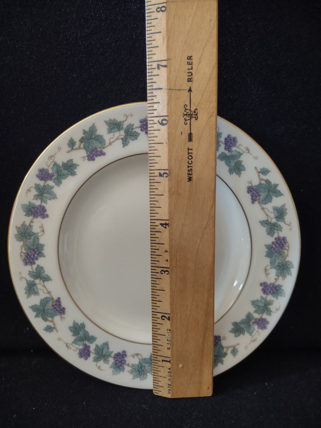 Vintage Theodore Haviland Arbor plate - angled view showing depth and grape vine border
