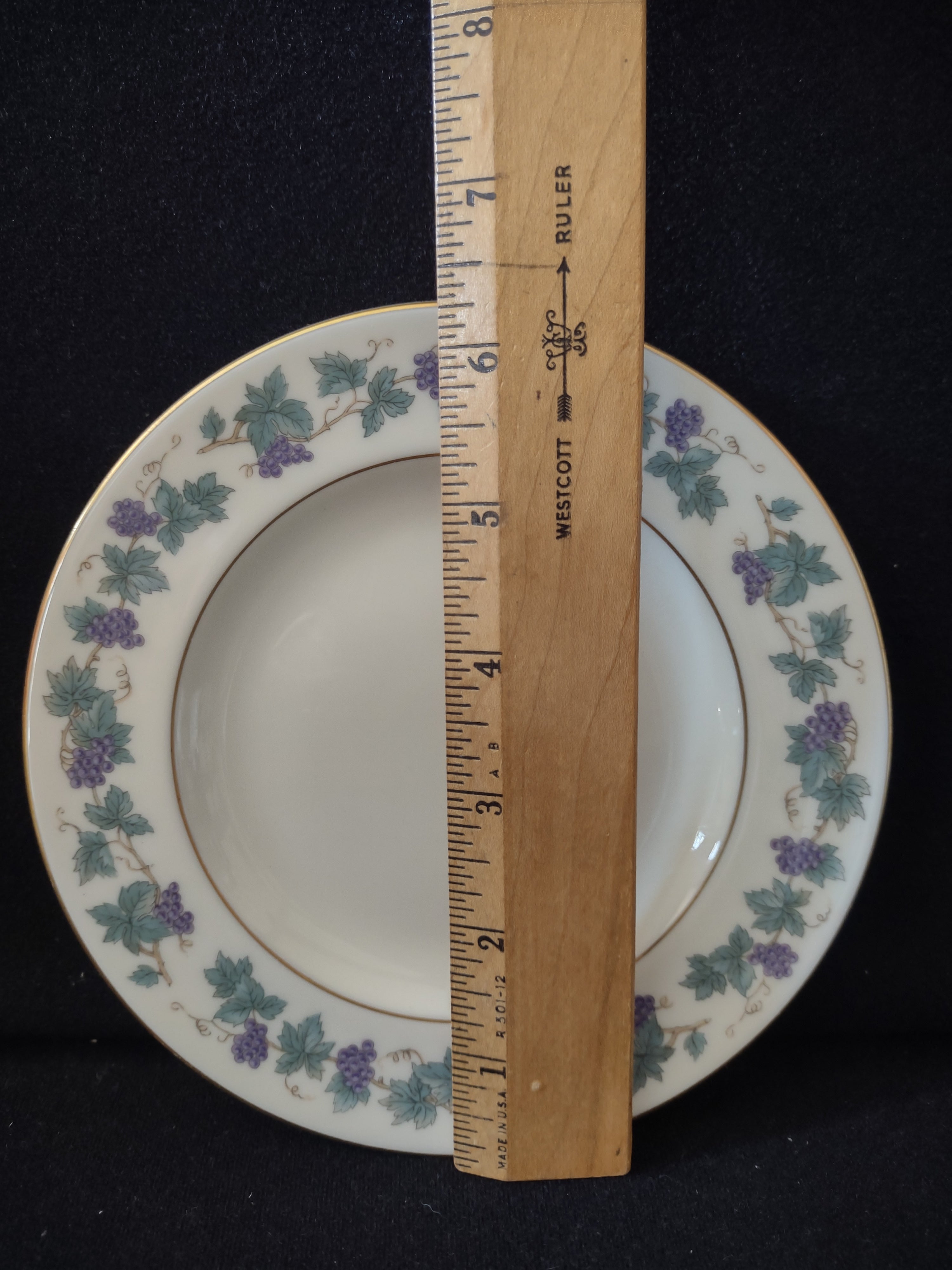 Vintage Theodore Haviland Arbor plate - angled view showing depth and grape vine border