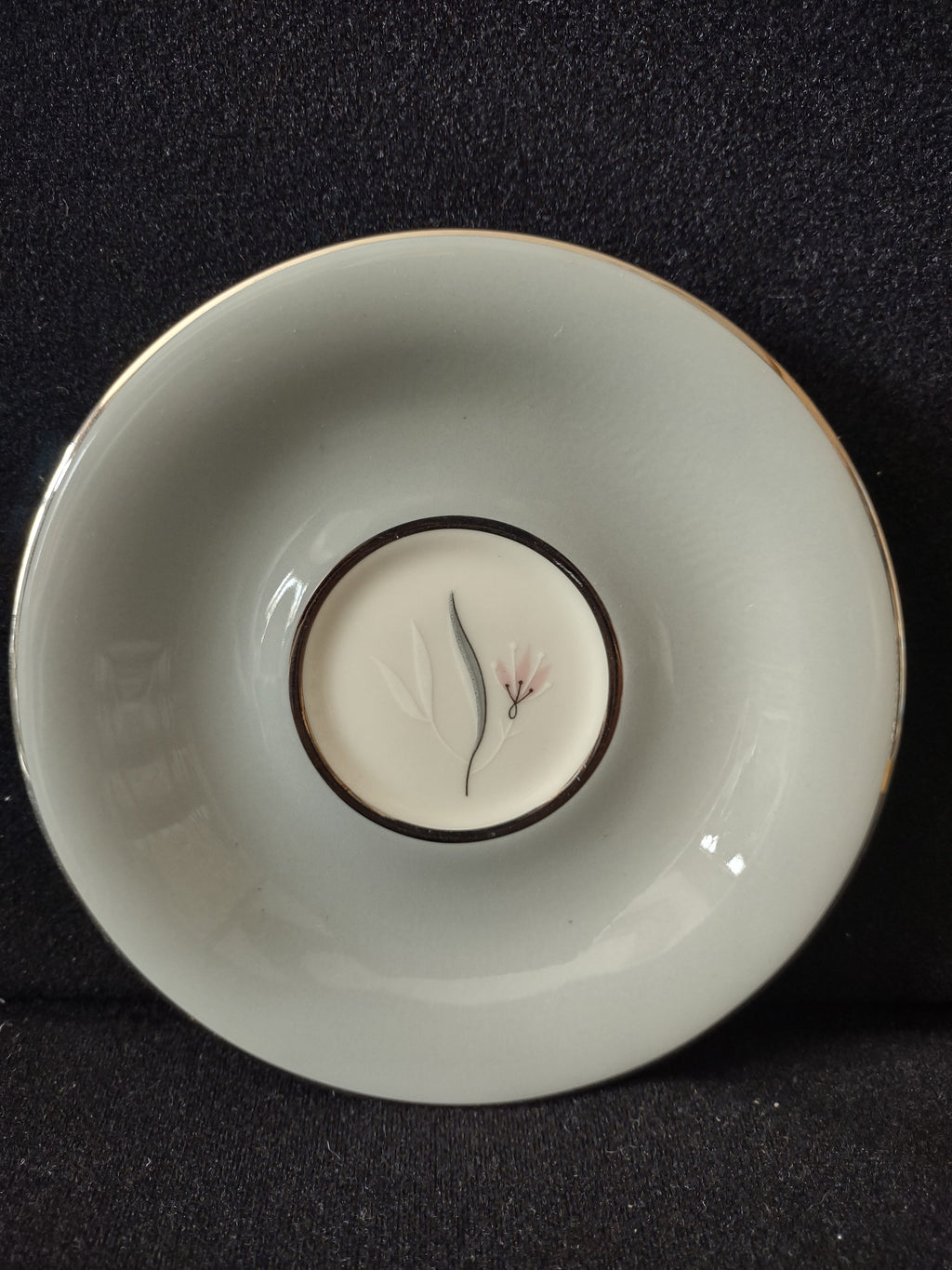 Castleton China Flair saucer top view showing gray leaf and pink floral motif with gold rim, approximately 6 inches diameter