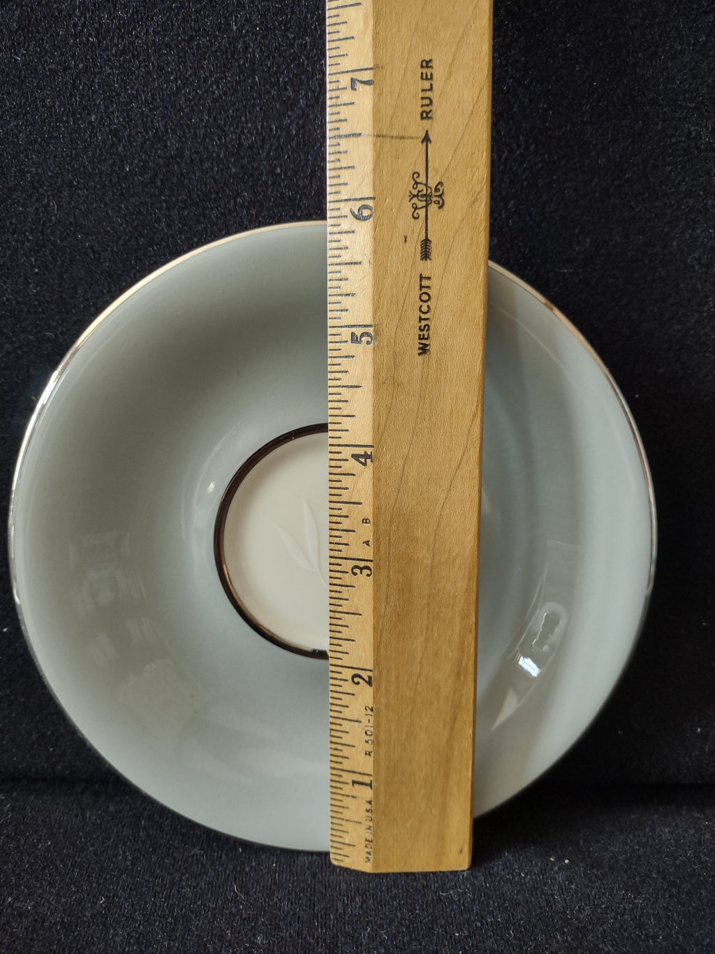 Castleton China Flair saucer with ruler showing approximately 6 inch diameter