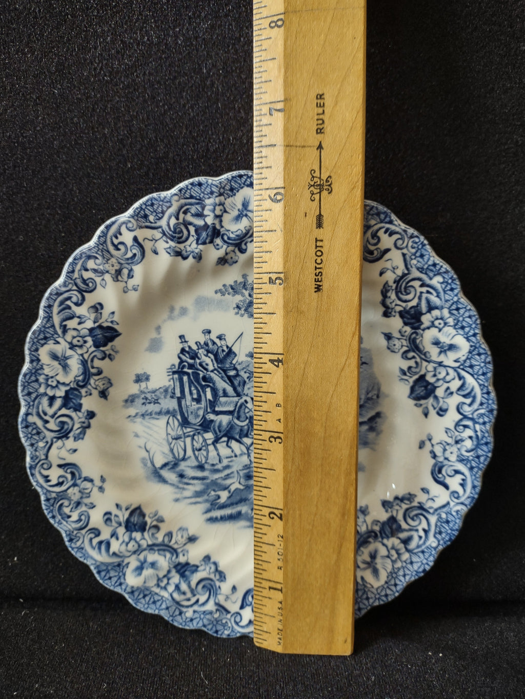 Johnson Bros Coaching Scenes Hunting Country blue transferware plate with scalloped edge, horse-drawn carriage scene at center, floral scroll border, approximately 6 inches diameter