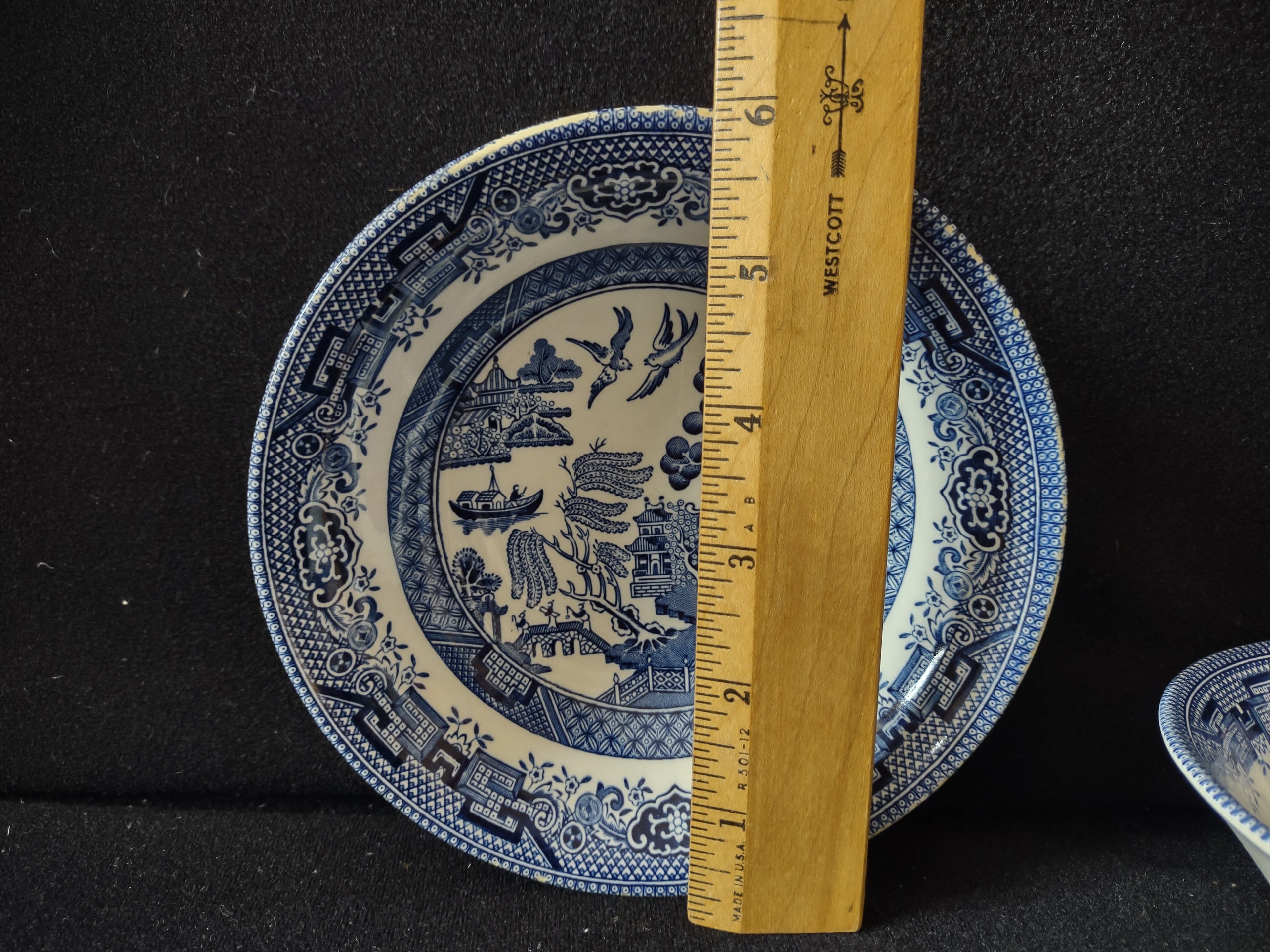 Churchill England Blue Willow saucer with ruler showing approximately 6 inch diameter