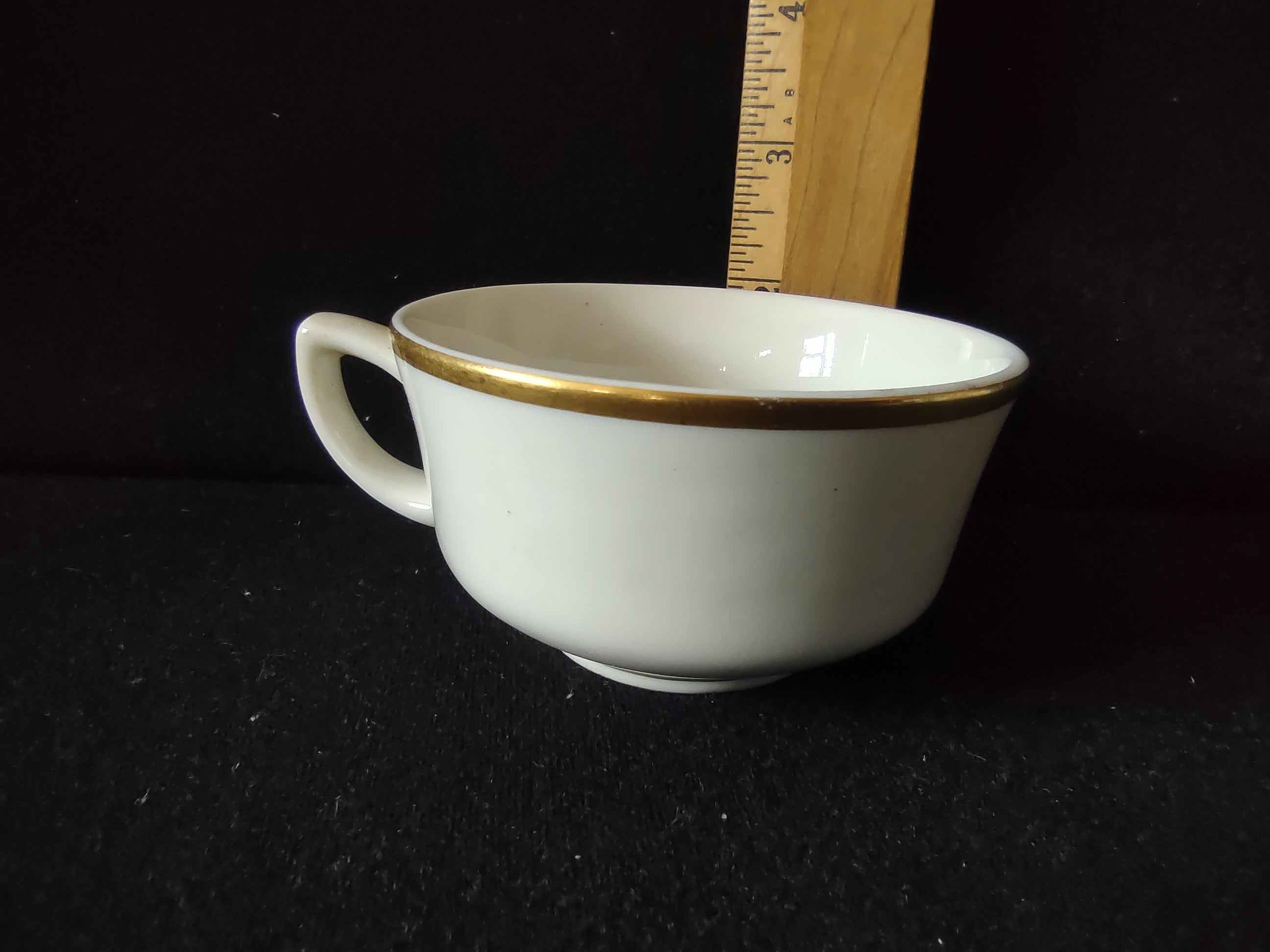 Close-up showing discoloration on body of tea cup consistent with age