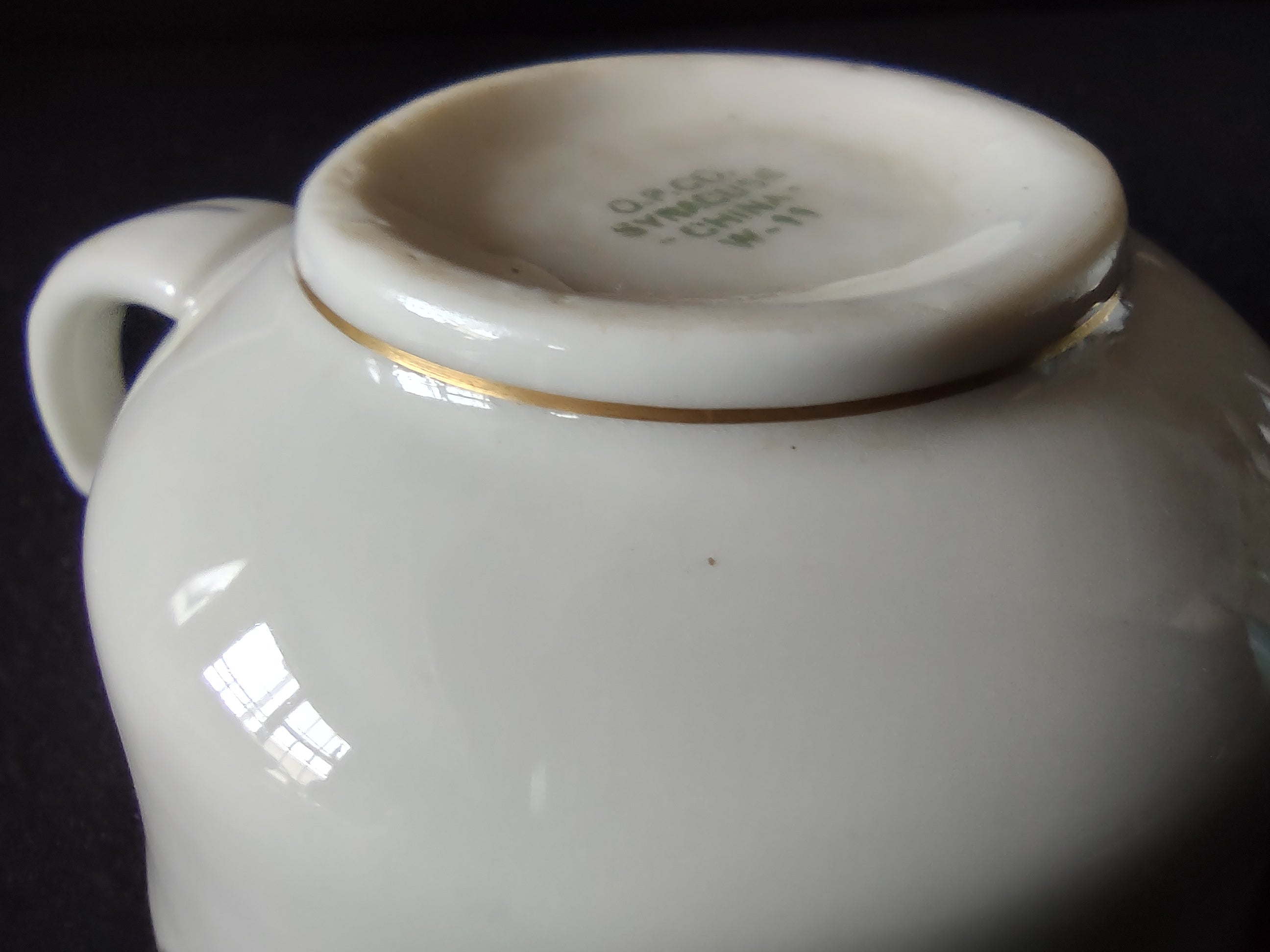 Side view of Syracuse China tea cup with ruler showing approximately 2.5 inch height