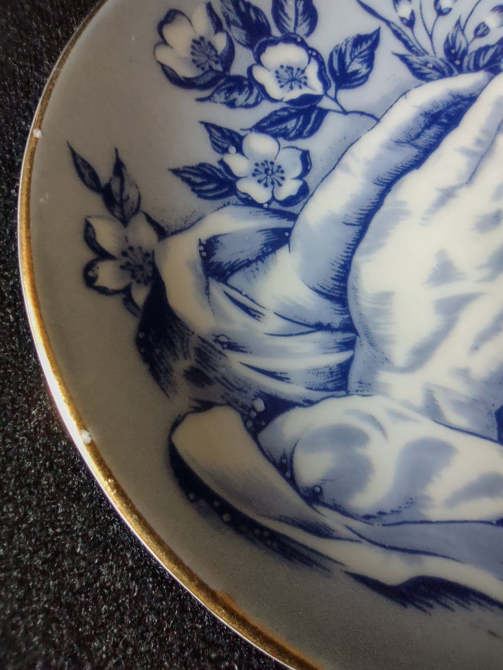 Vintage blue white praying hands plate close-up showing chip on rim