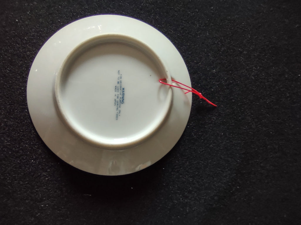 Vintage blue white praying hands plate back view showing maker mark and red cord hanger