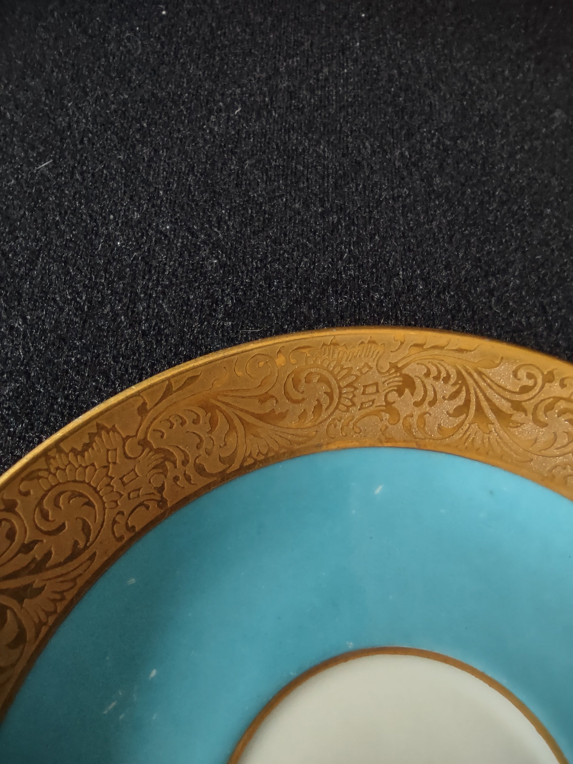 Turquoise saucer with gold border angled view