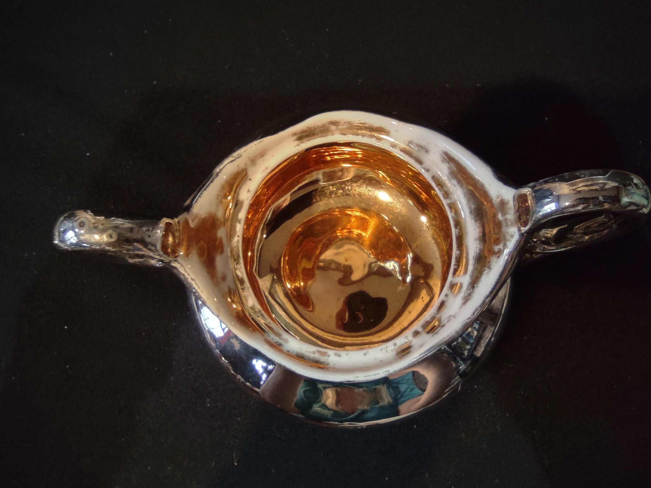 Creamer interior showing copper discoloration from silver wear