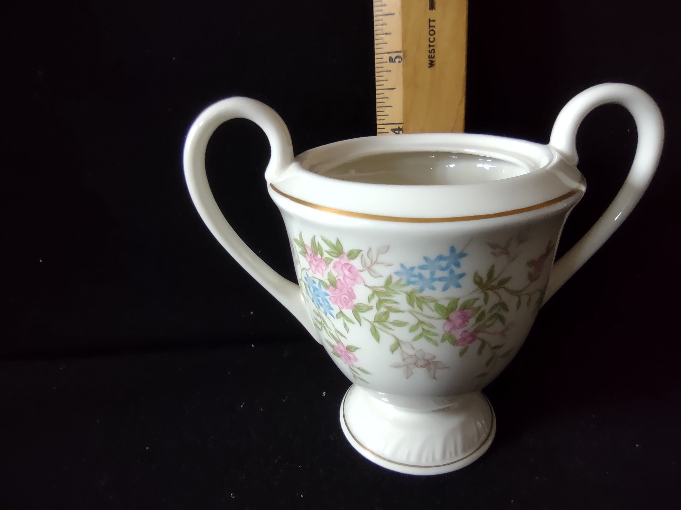 Vintage floral open sugar bowl close-up of pink roses and blue flowers