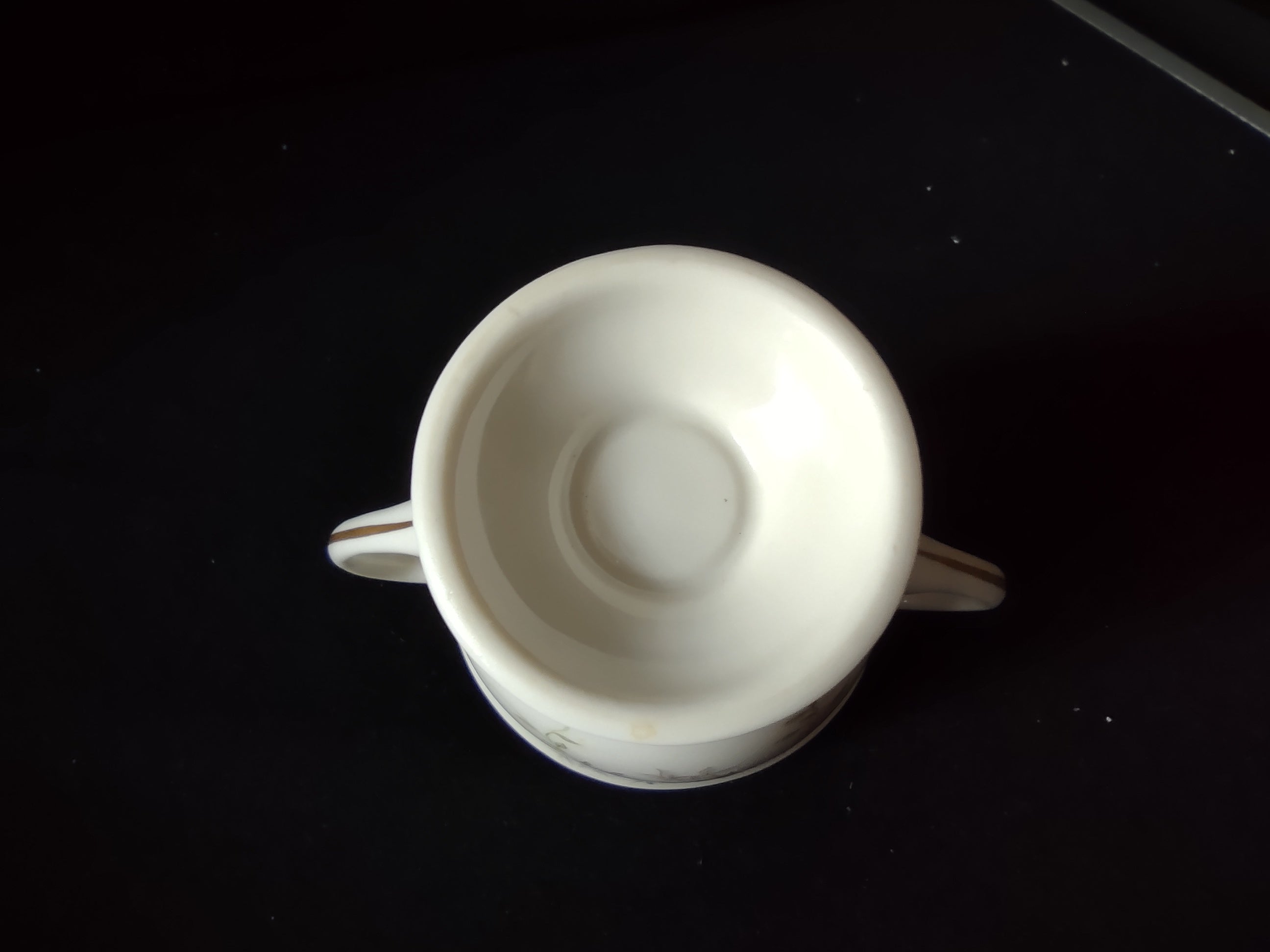 Vintage floral open sugar bowl close-up of footed base with gold trim