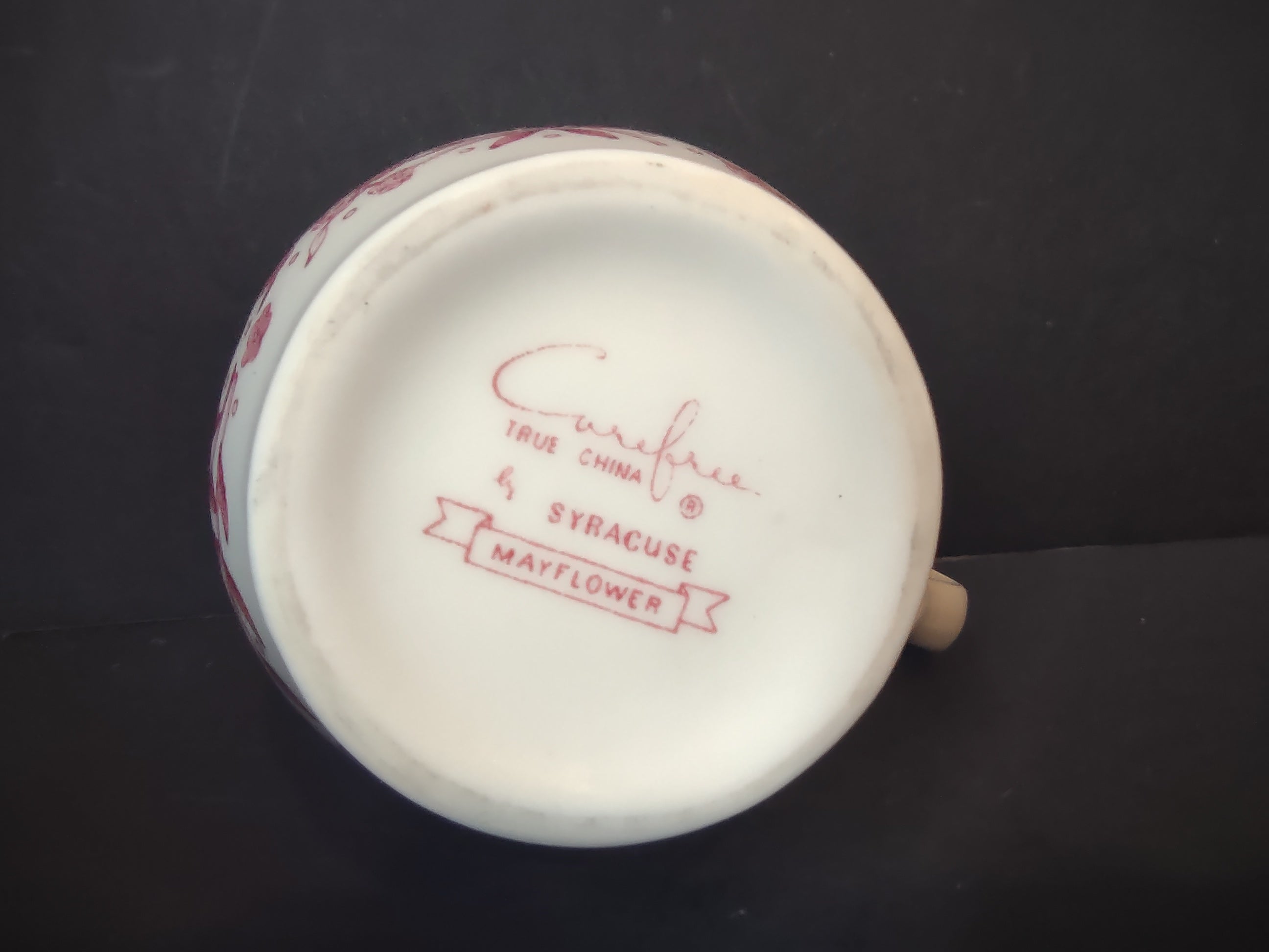 Backstamp of Vintage Syracuse China Carefree True China Mayflower pattern mark in cranberry pink