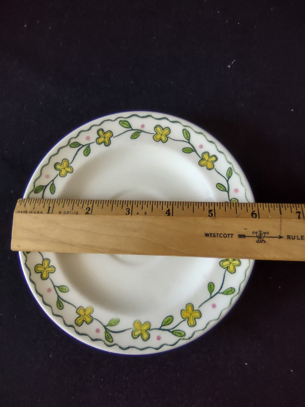 Watt Pottery Happy Time saucer with ruler showing approximately 6 inch diameter