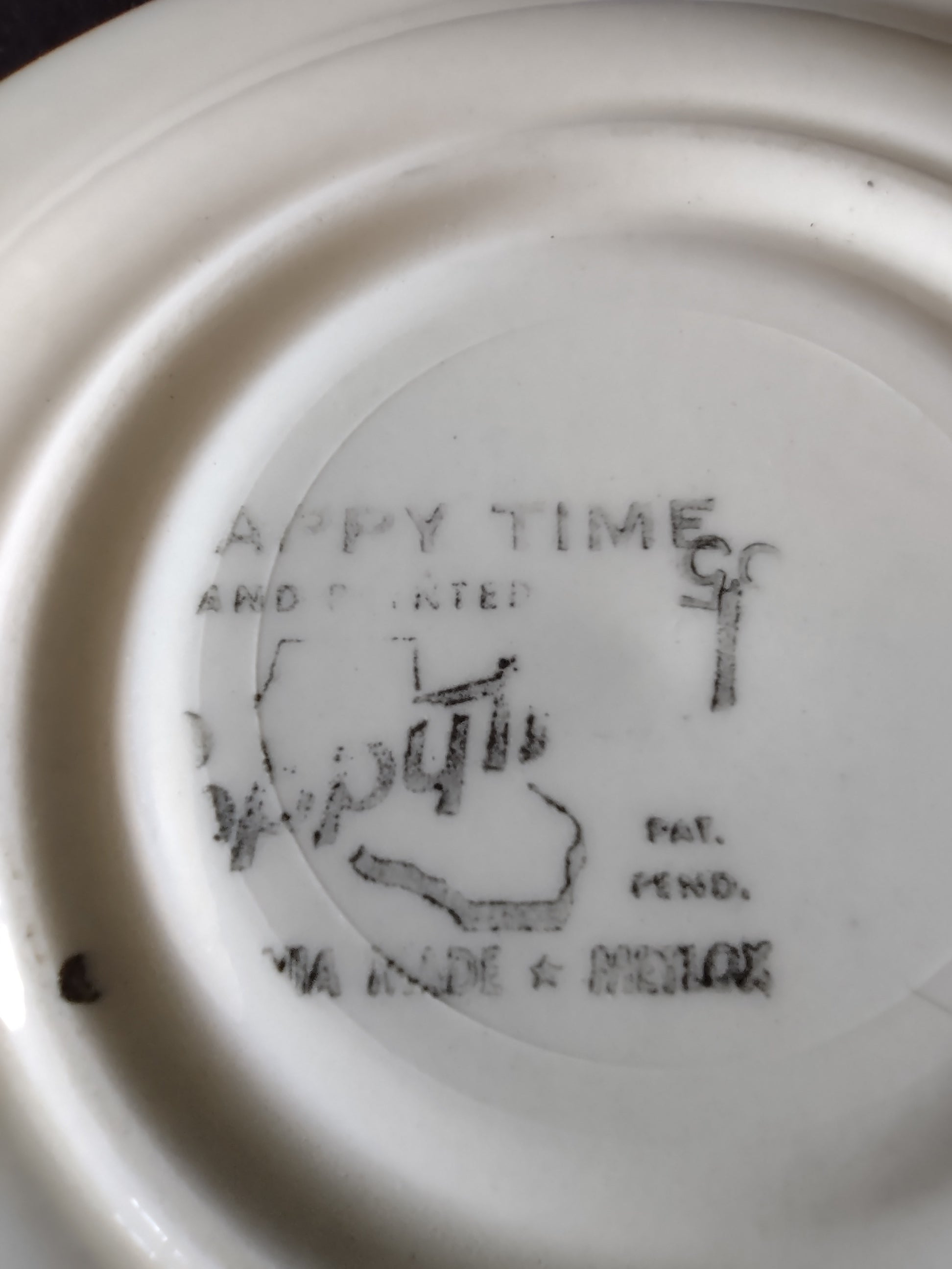 Bottom of Watt Pottery Happy Time saucer showing hand painted backstamp and Pat. Pend. mark