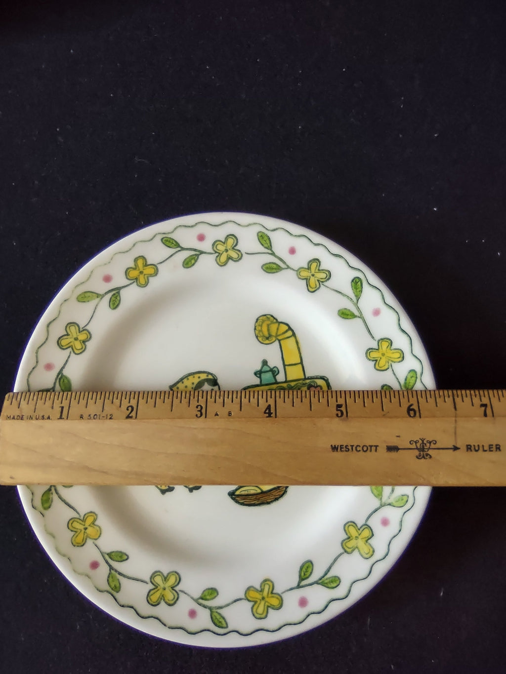 Vintage Metlox Poppytrail Happy Time saucer with ruler showing approximately 6 inch diameter