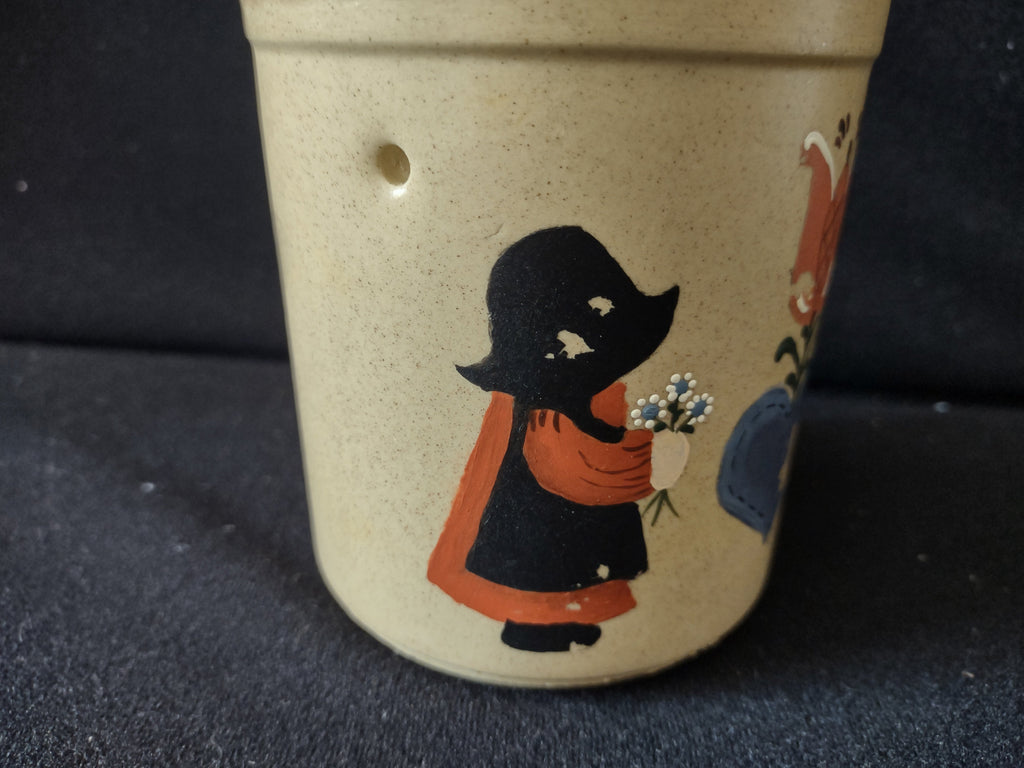 Vintage stoneware crock folk art detail close-up