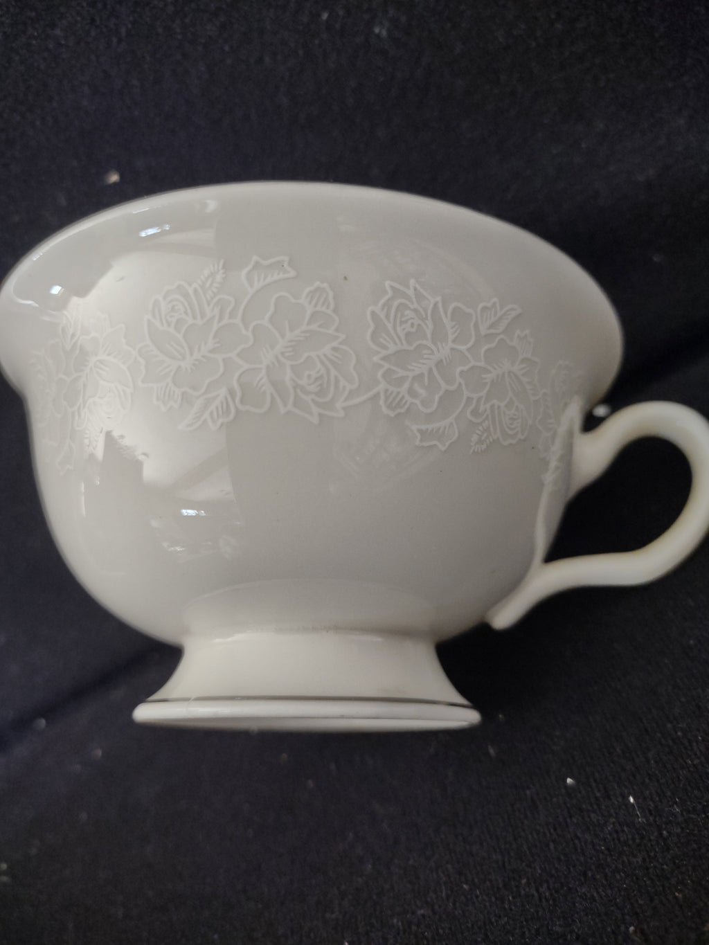 Vintage Cathedral Fine China footed teacup close-up of embossed rose pattern