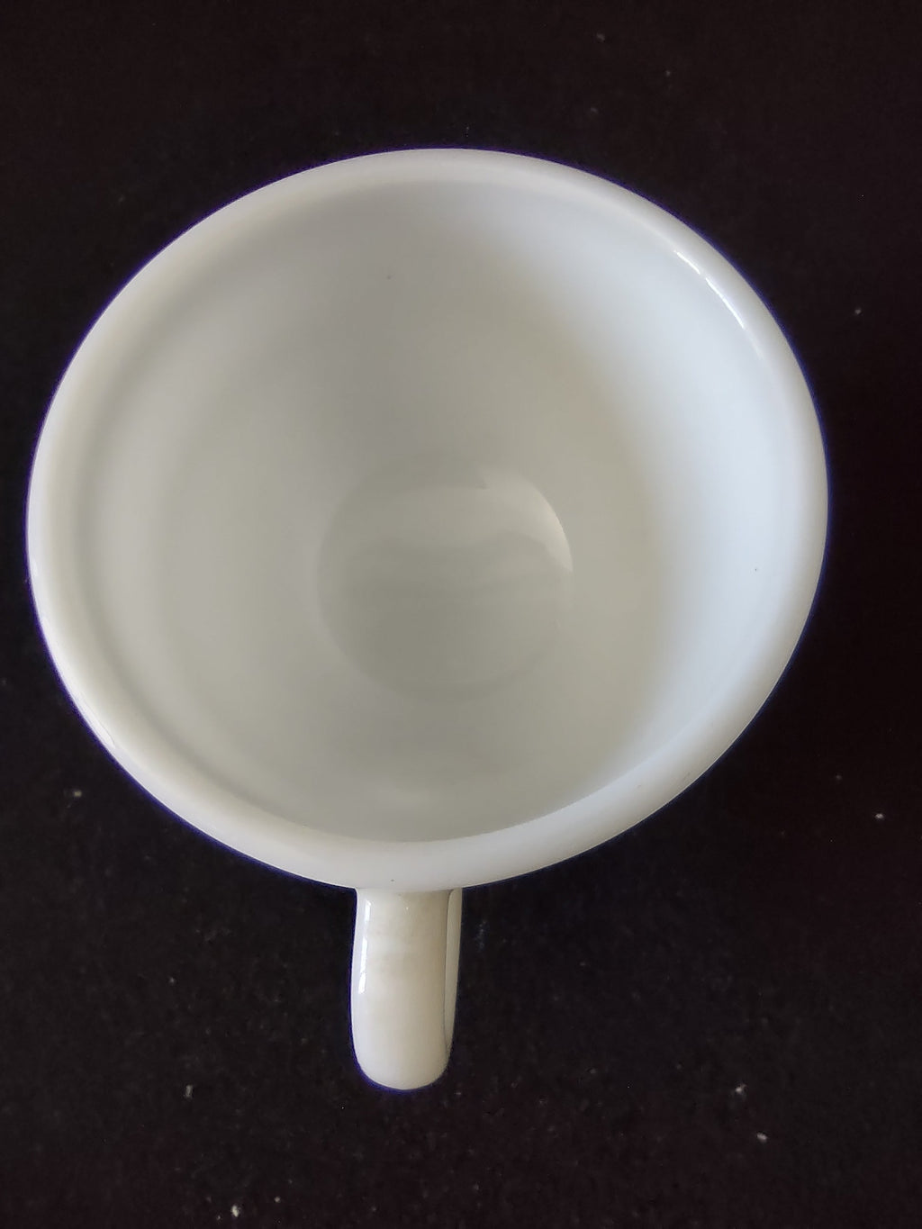 Side view of vintage Buffalo China white milk glass green stripe diner cup with ruler