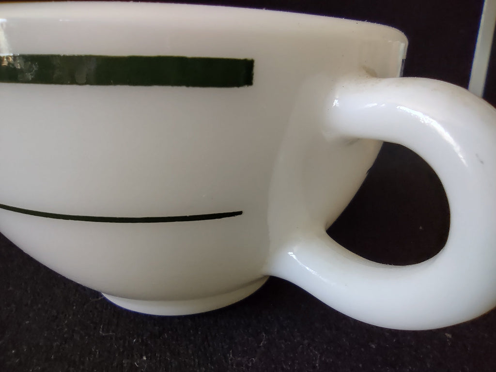 Side profile of vintage Buffalo China white milk glass green stripe diner cup